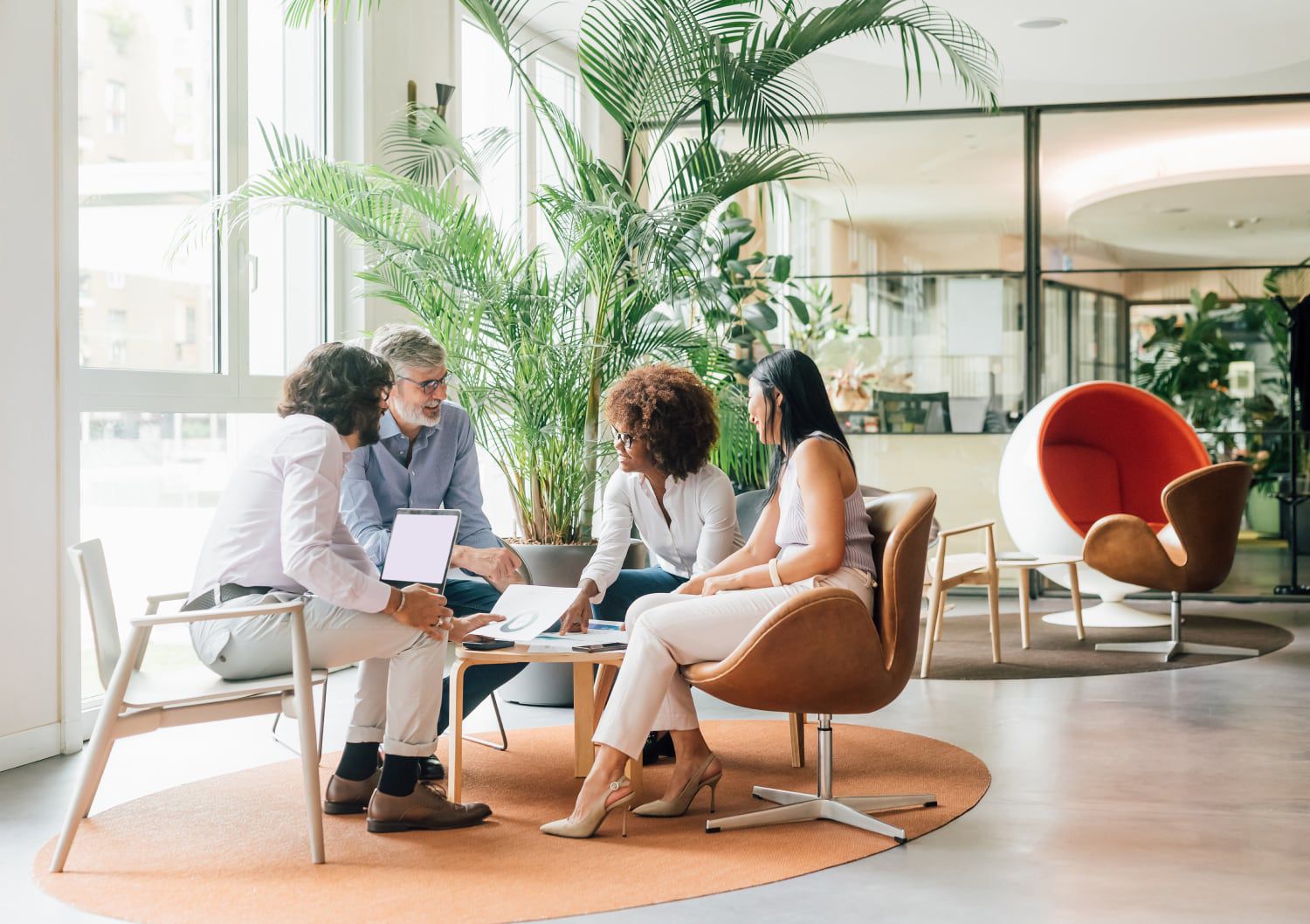 Business people gathered around in a lobby seating area