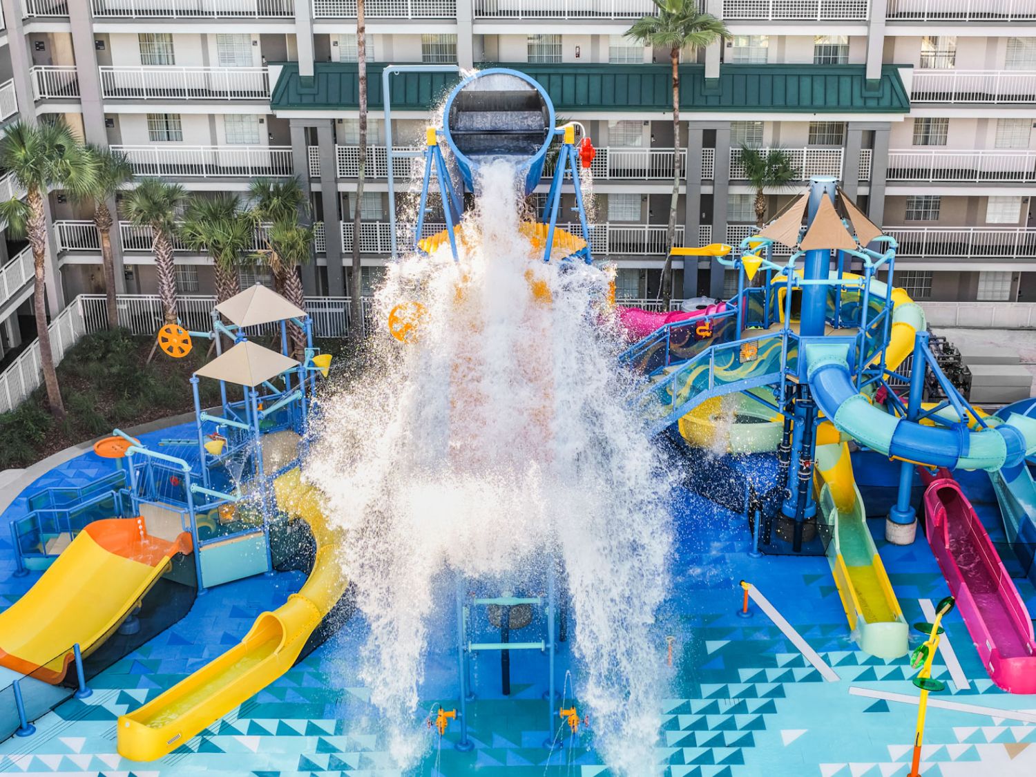 Aerial shot of resort pool with multiple water features and play areas