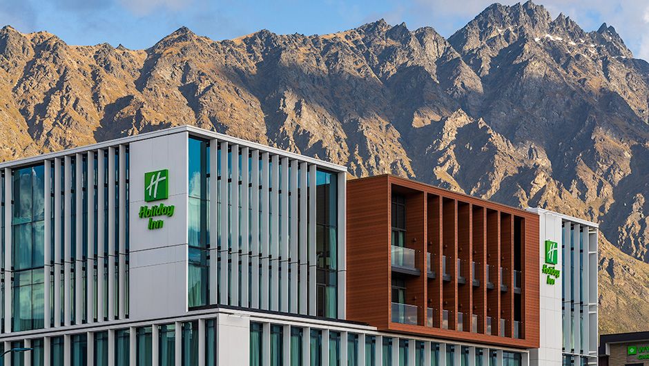 Holiday Inn Queenstown Remarkables Park hotel exterior facade with moutain backdrop