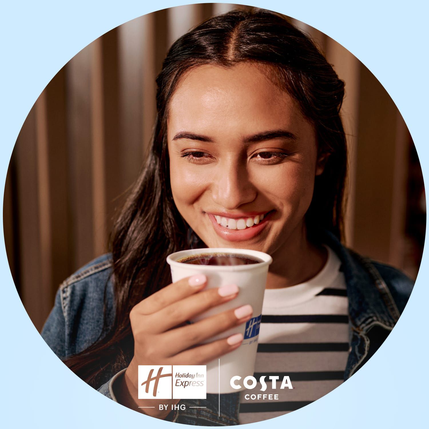 A woman enjoying a fresh brewed cup of coffee.