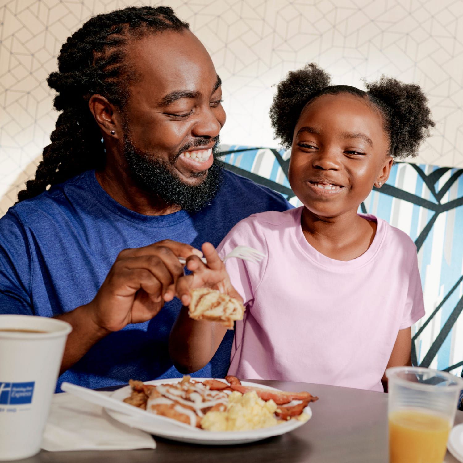 Family laughing and enjoying breakfast together at a table