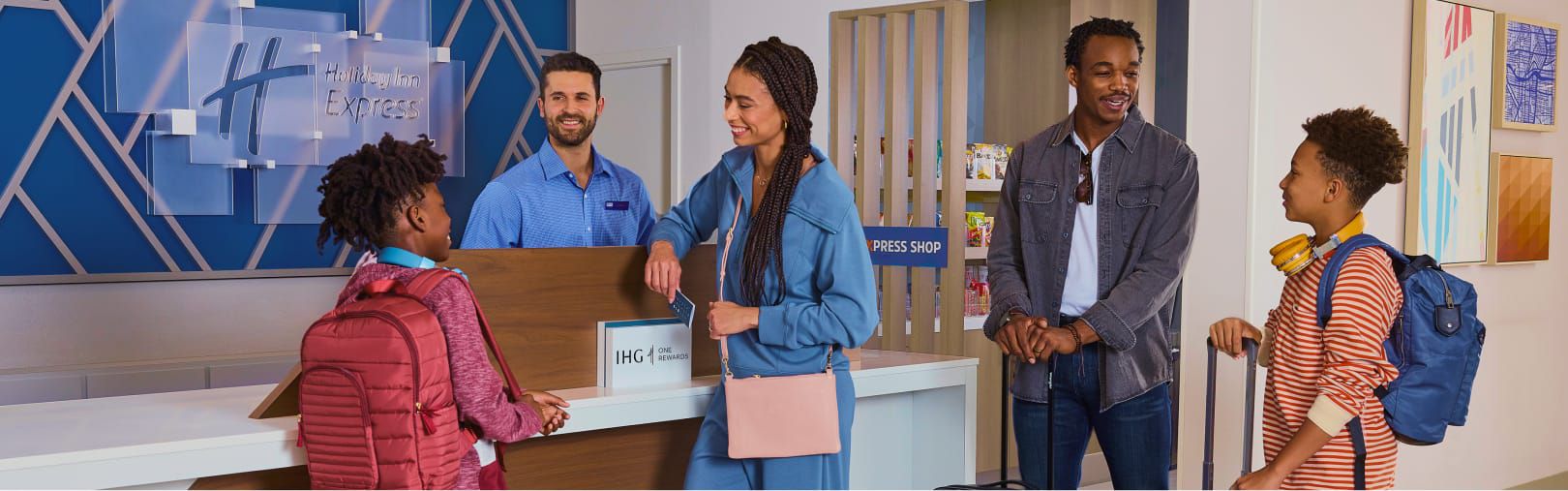 A family checking in at the Holiday Inn Express front desk.