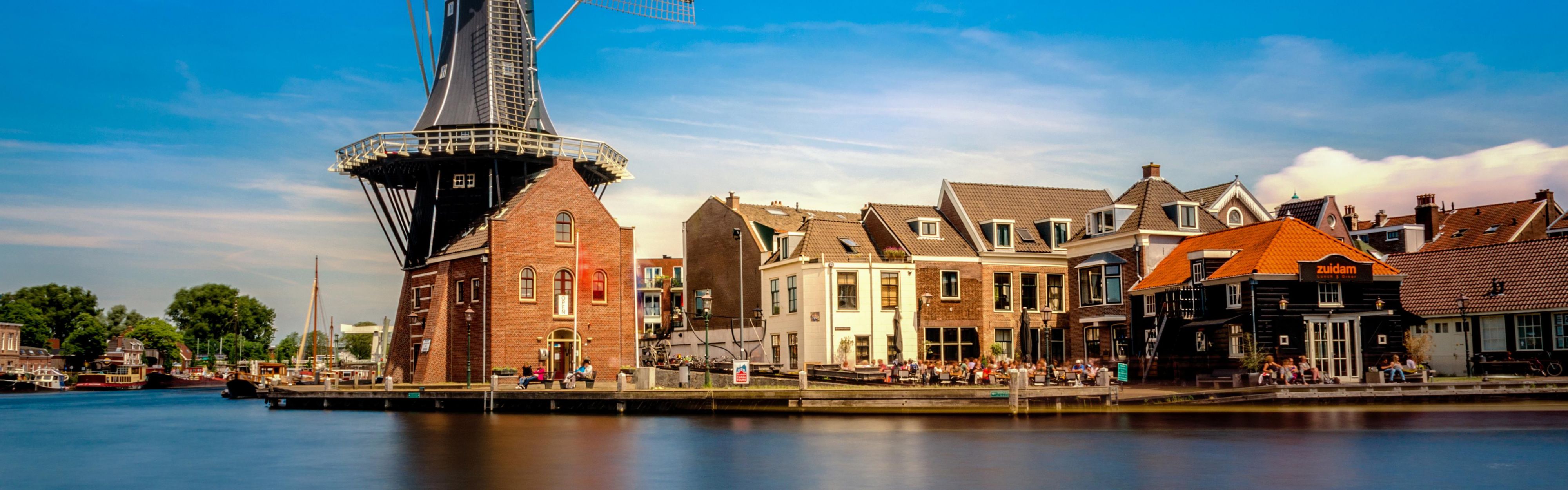 Discover the charm of Haarlem at the windmill on the riverbank.