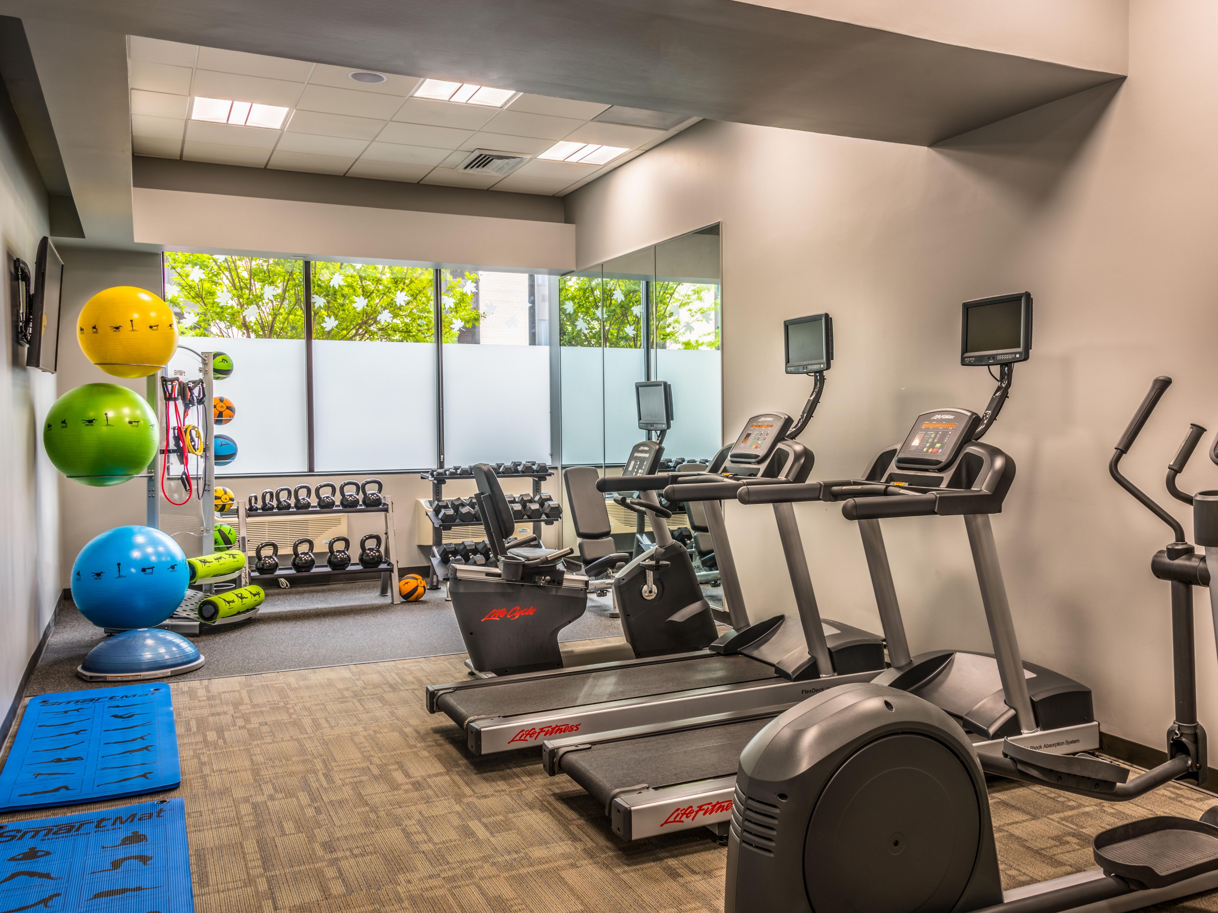 Stay active and energized anytime at our 24-hour Fitness Center, equipped with an elliptical, bikes, treadmill, exercise balls, and free weights. Enjoy complimentary towels, water, and a TV to enhance your workout experience. 