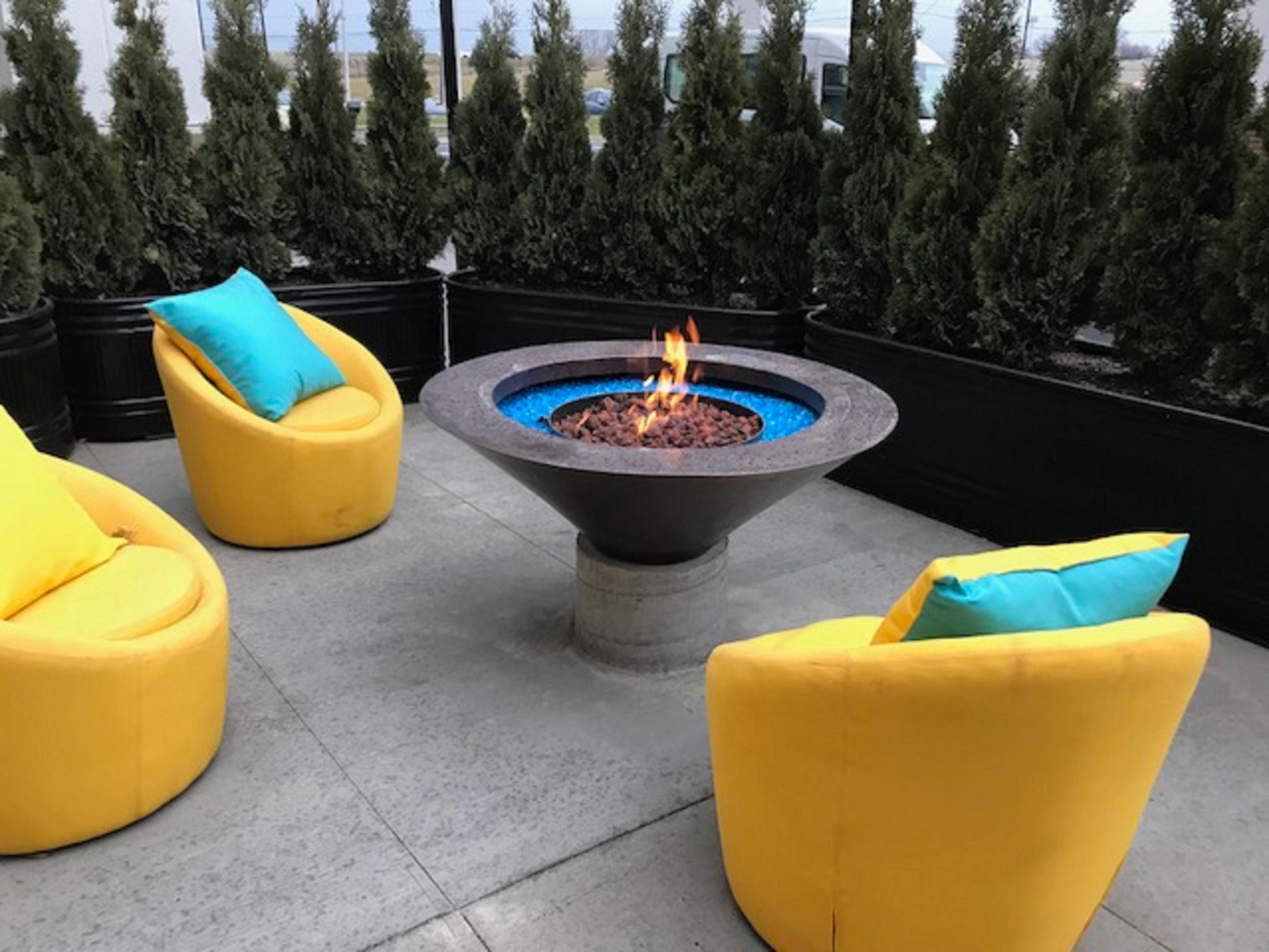 Grab your favorite beverage and cozy up around the fire! Our modern outdoor firepit and patio is located just outside our Media Room.  