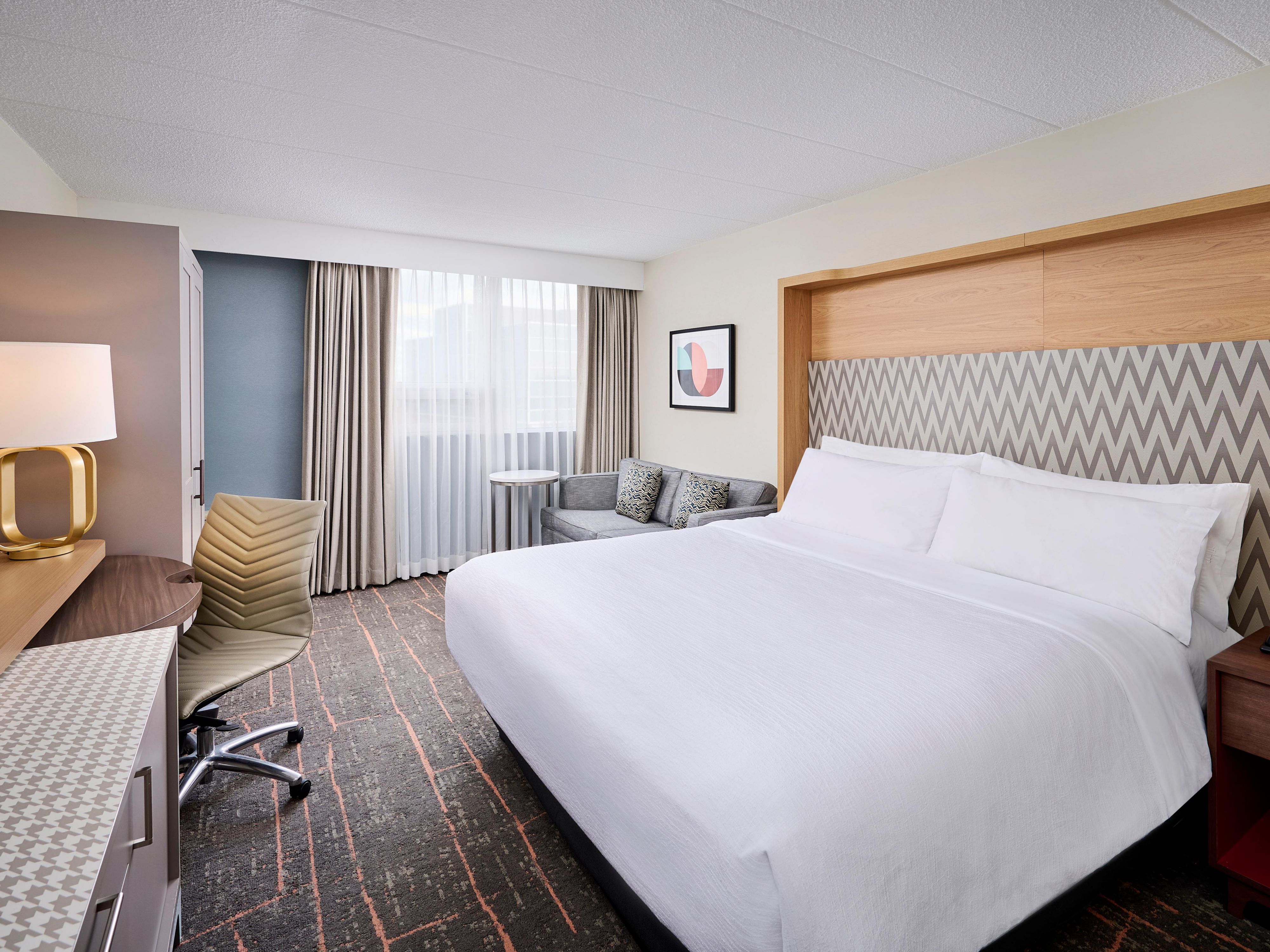 Unwind in our spacious king standard suite with premium bedding.