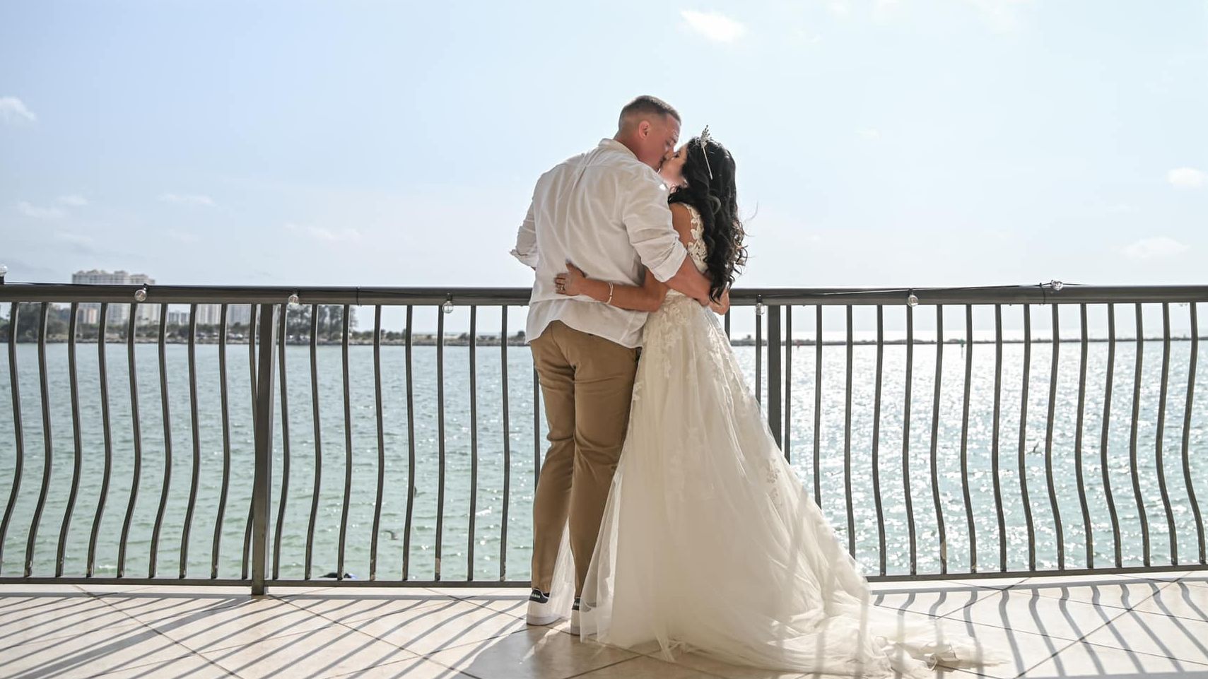 Bride and groom on balcony with water view