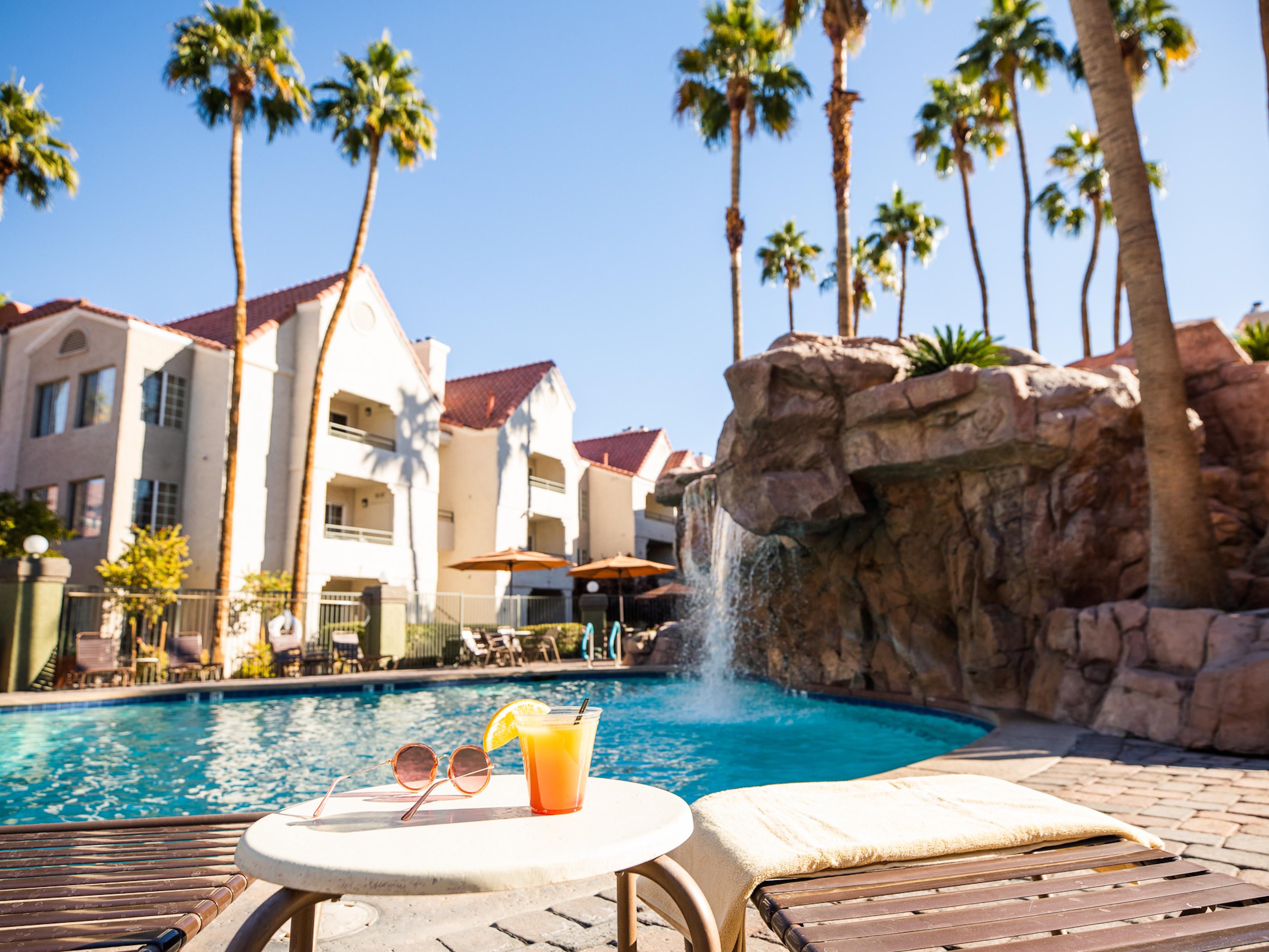 Swimming pool with rock waterfall. 