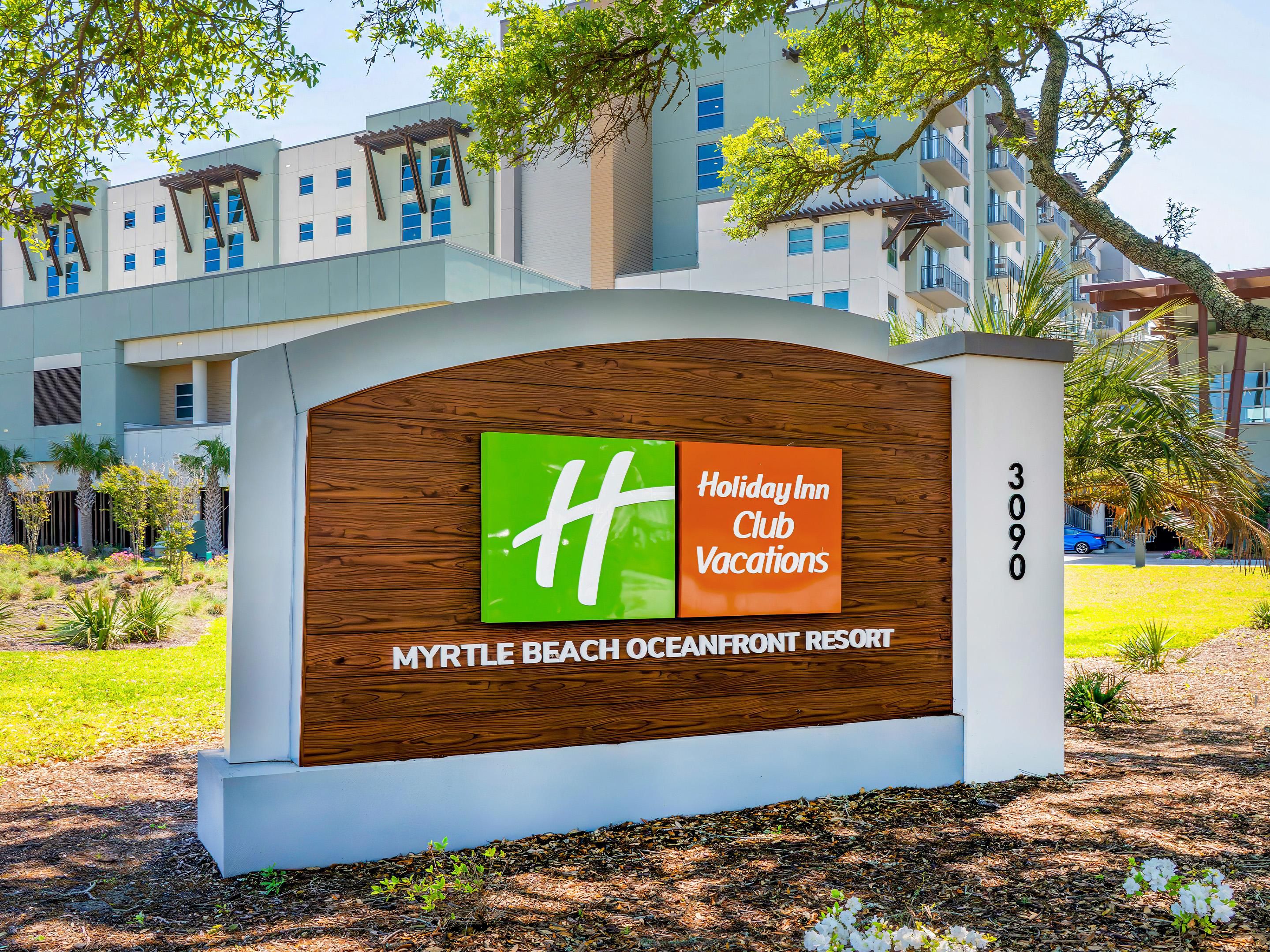 The resort entrance sign stands before the main building.