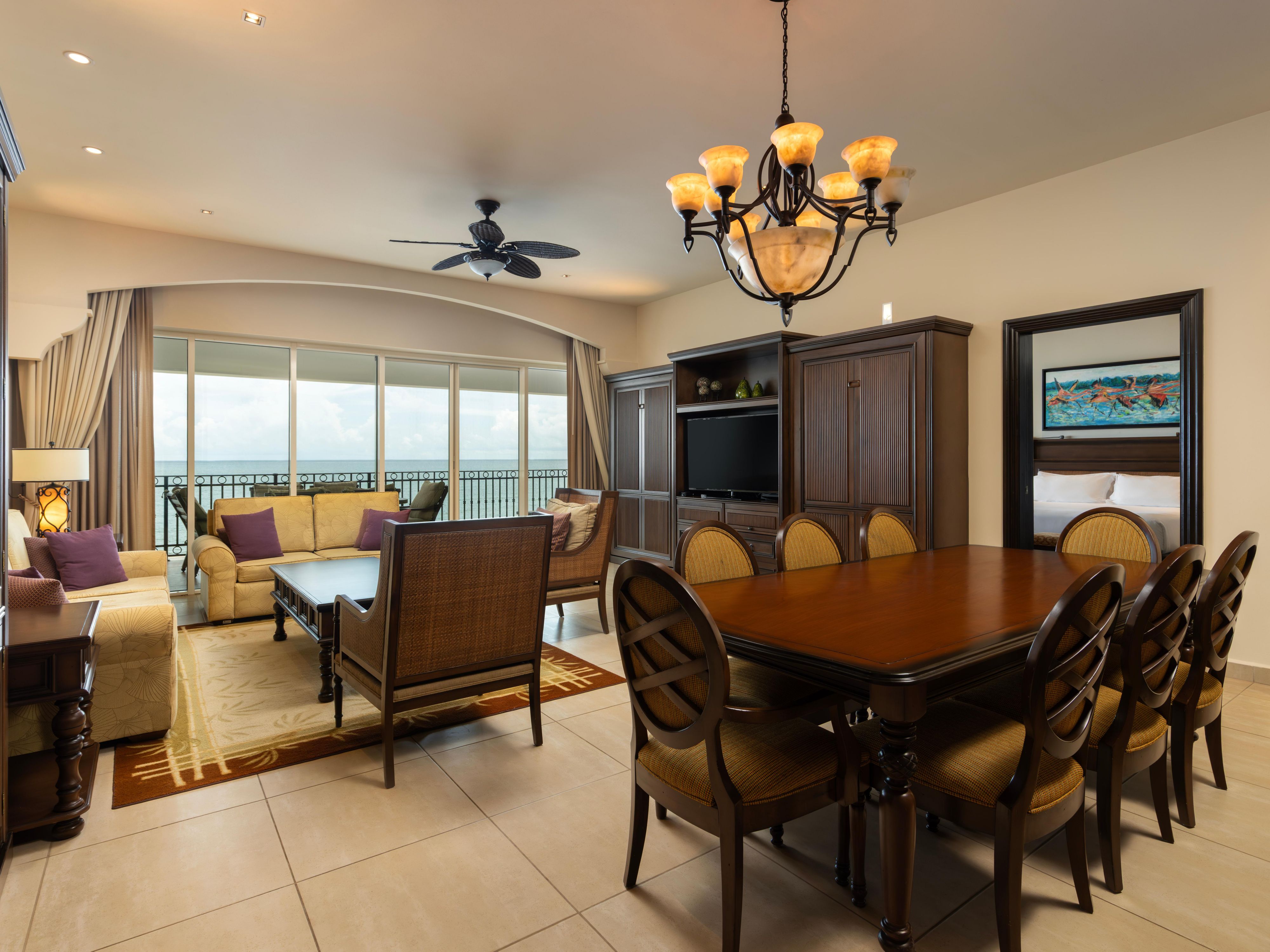 Ocean-facing suite with dining area, daybed, and balcony.