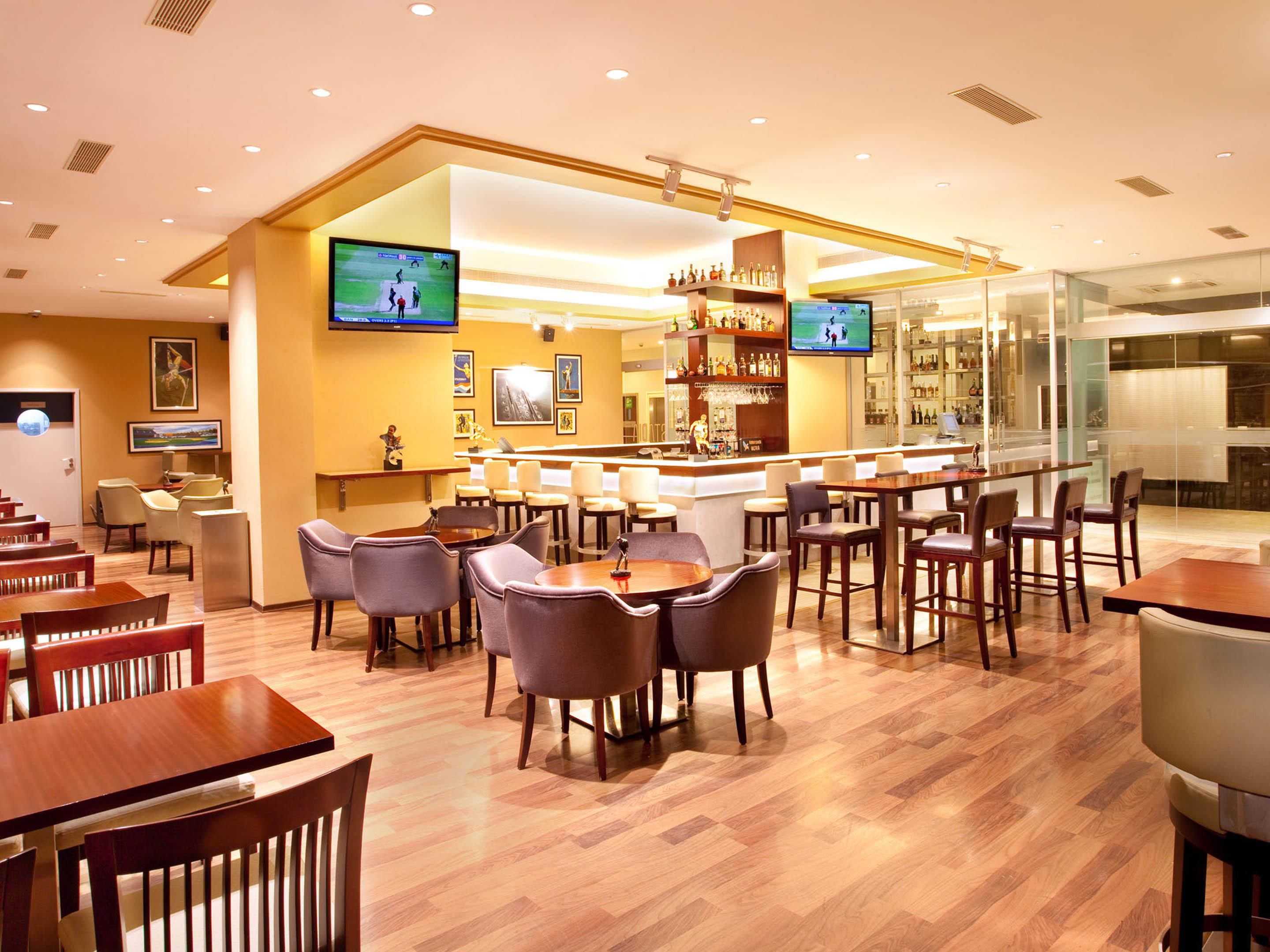 Experience the exclusive sports-themed bar at Holiday Inn Cochin - Stadia. Be captivated by its trendy seating, pool table, vibrant music, DJ performances, and large screens broadcasting your beloved sports events. Gather your friends and family to cheer for your favorite team while relishing your preferred drink.