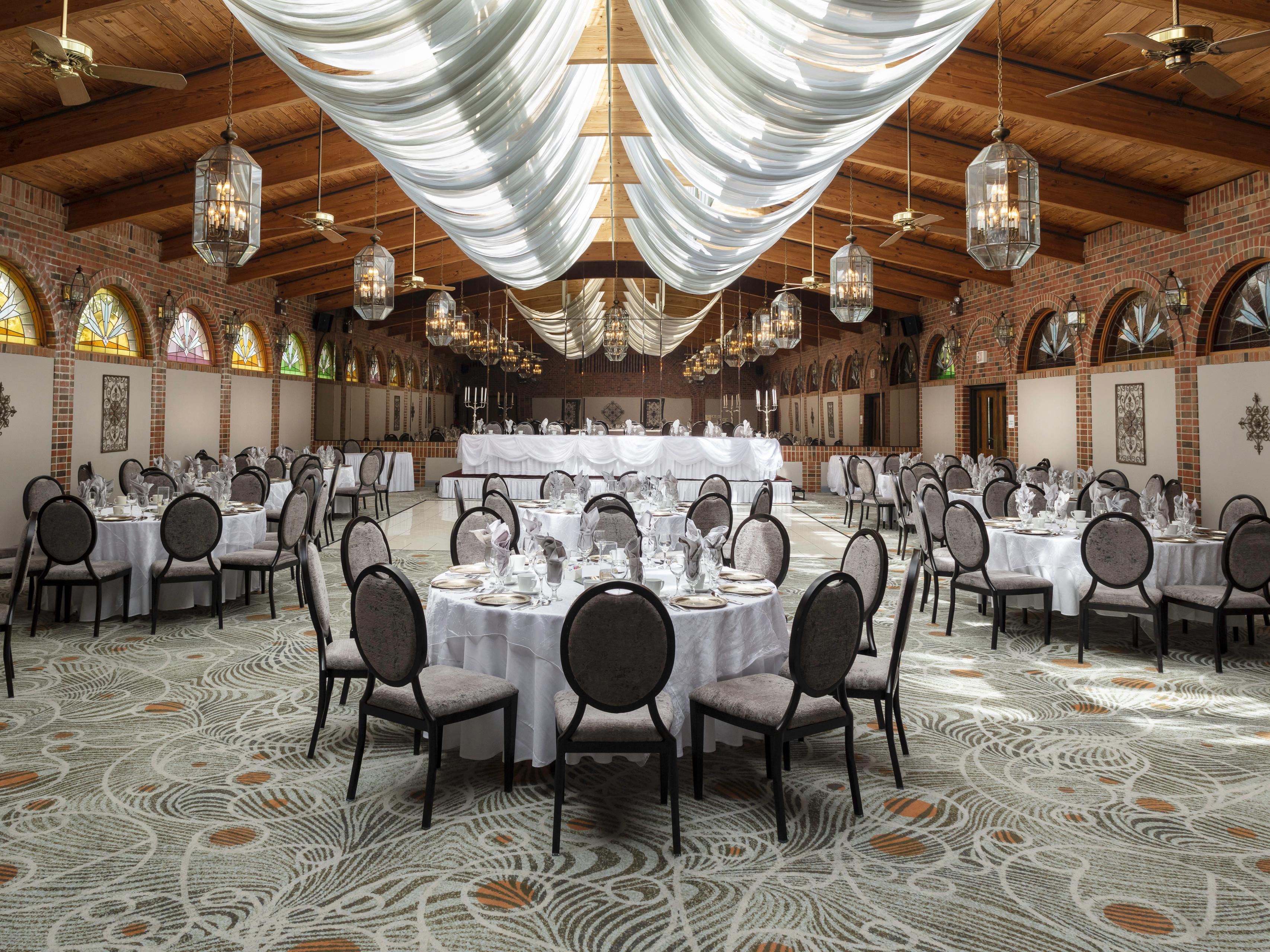 From small intimate gatherings to large family affairs, our elegantly remodeled banquet rooms are tailored to fit your special event! The one-of-a-kind Atrium Ballroom may comfortably accommodate up to 330 wedding guests and offers a charming, rustic ambiance along with a beautiful fireplace, outdoor patio, vaulted ceiling, and natural lighting!