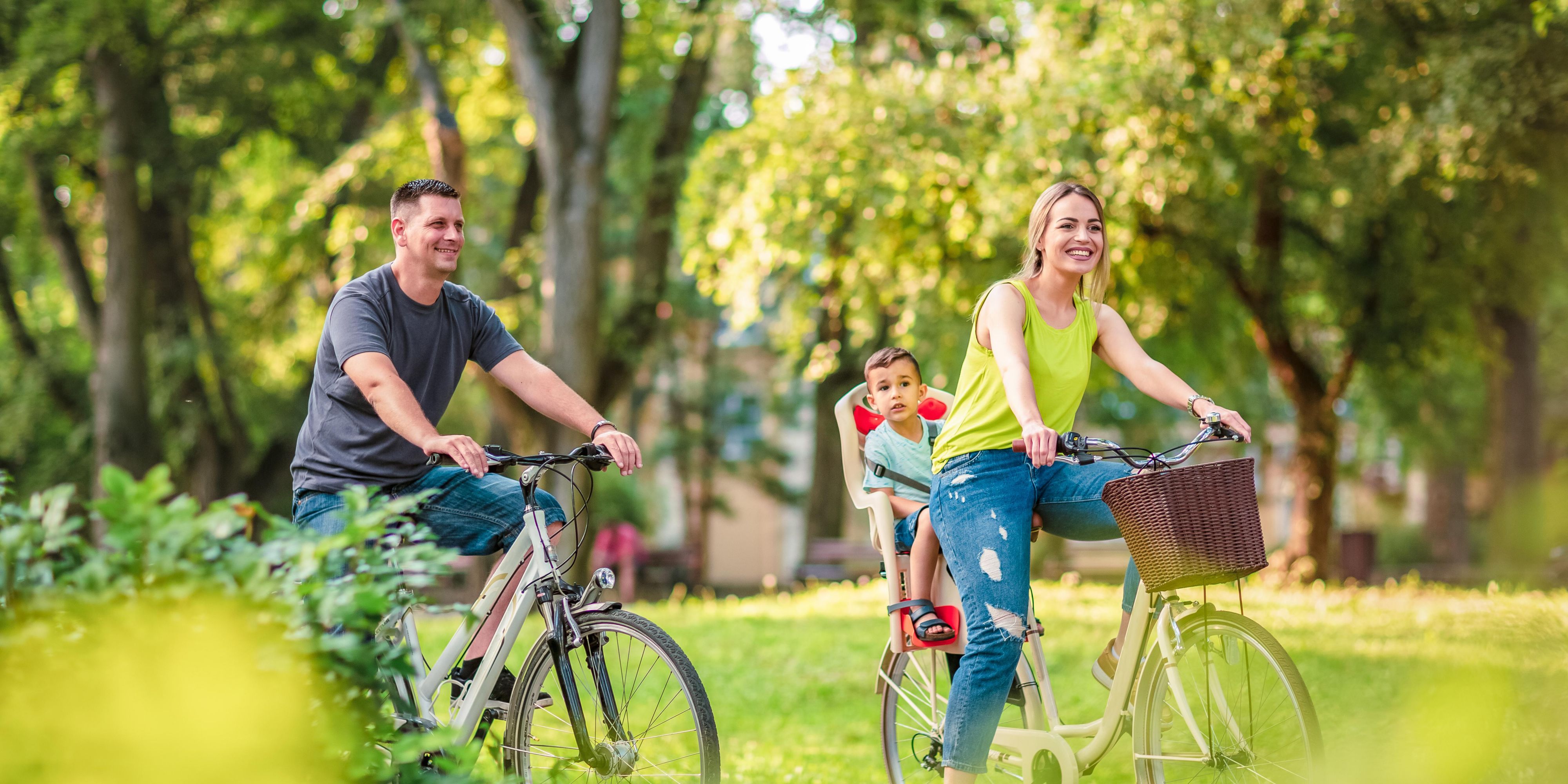 Couple riding bikes in park
