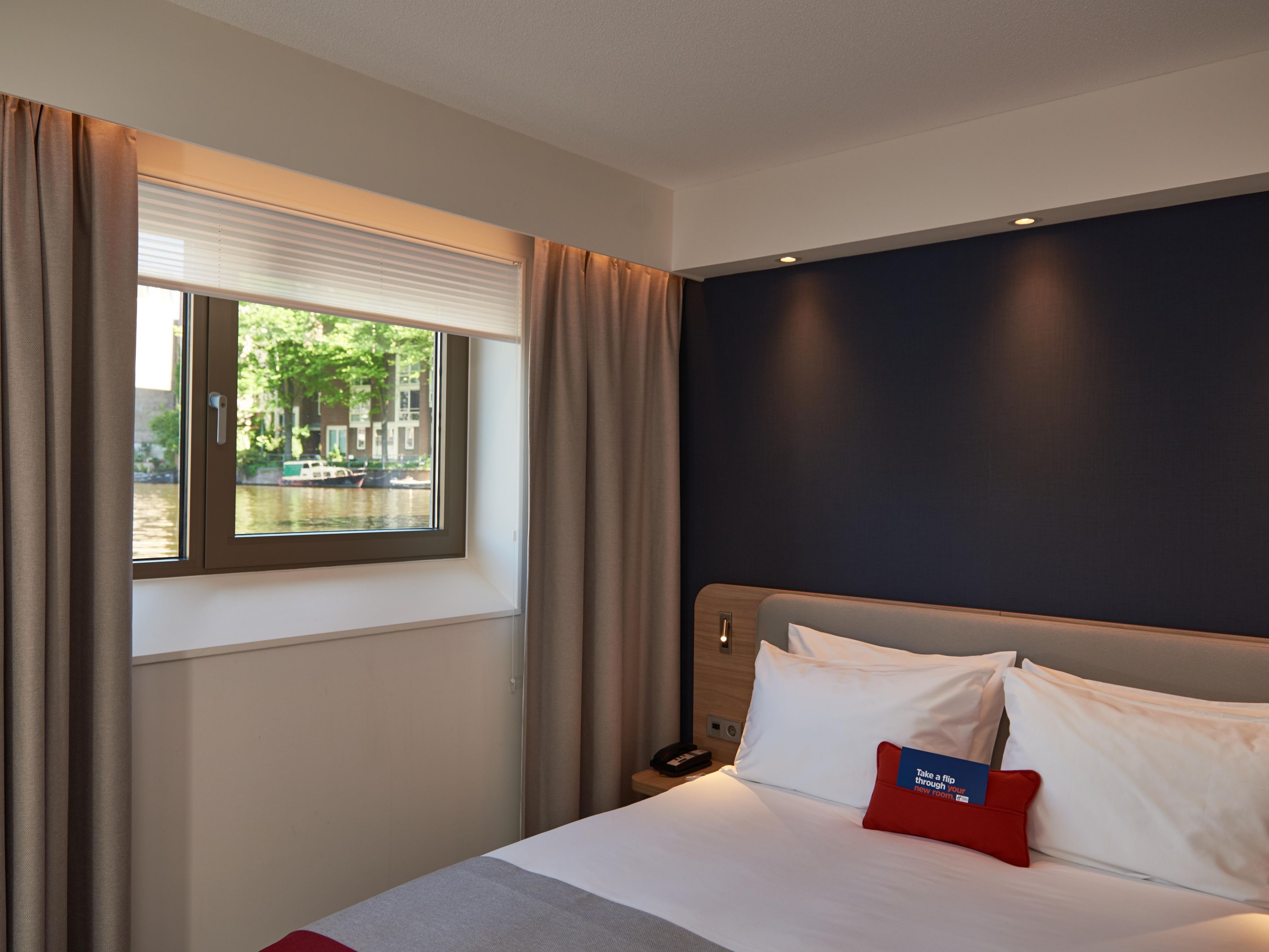 Enjoy a relaxing stay in our air-conditioned Double Room with Canal View. This modern room features a comfortable double bed, private bathroom with walk-in shower, hairdryer, and free toiletries. Amenities include a flat-screen TV, tea and coffee maker, wardrobe, and safe deposit box.