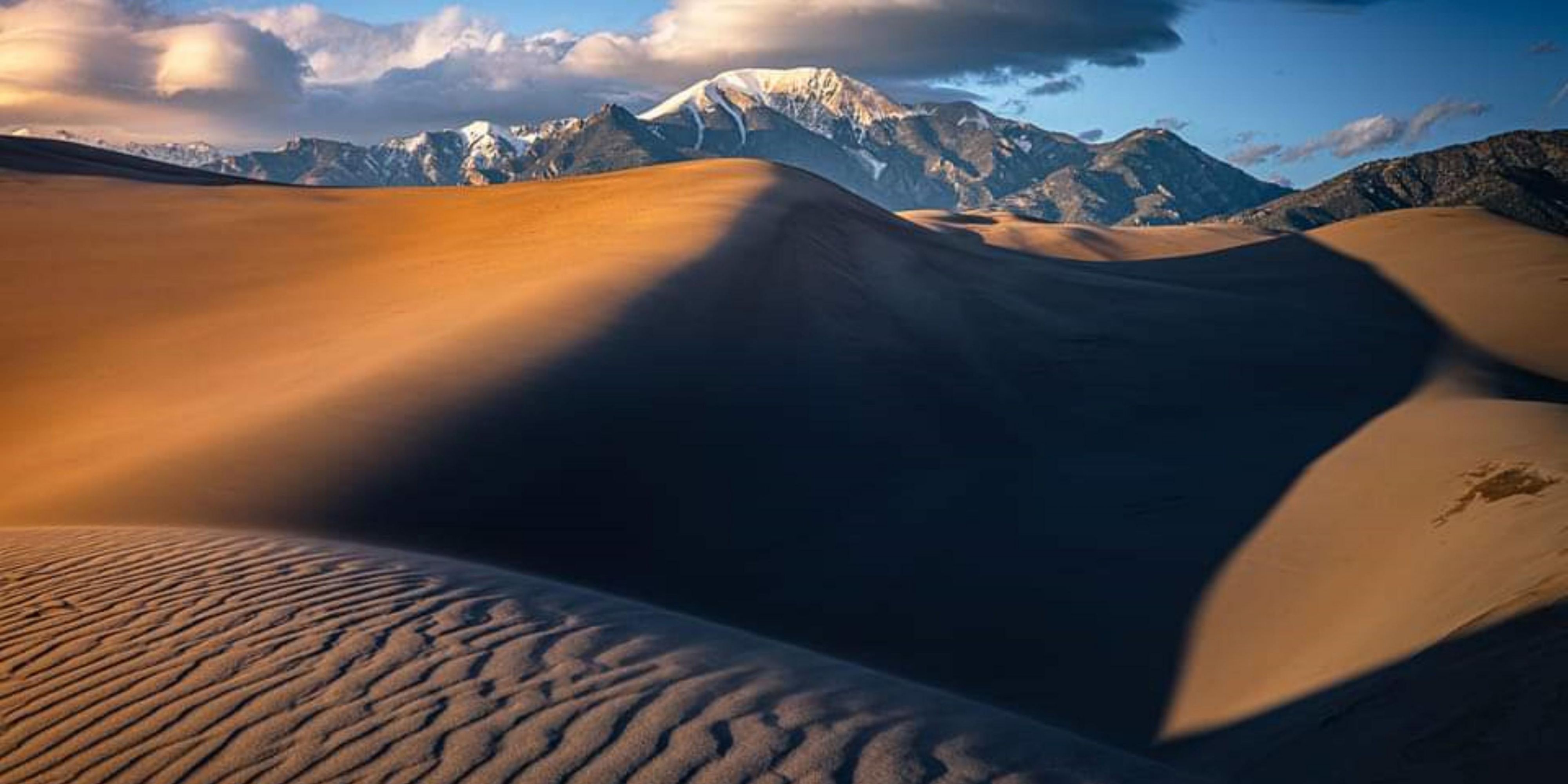 To explore, to experience, to spread your roots! We invite you to visit Alamosa. Let us guide you along trails less traveled in the San Luis Valley, show you where to get the best bowl of Green Chile, and even share our sacred fishing spots on the magnificent Rio Grande.
Play at Great Sand Dunes National Park or hike to Zapata Falls 