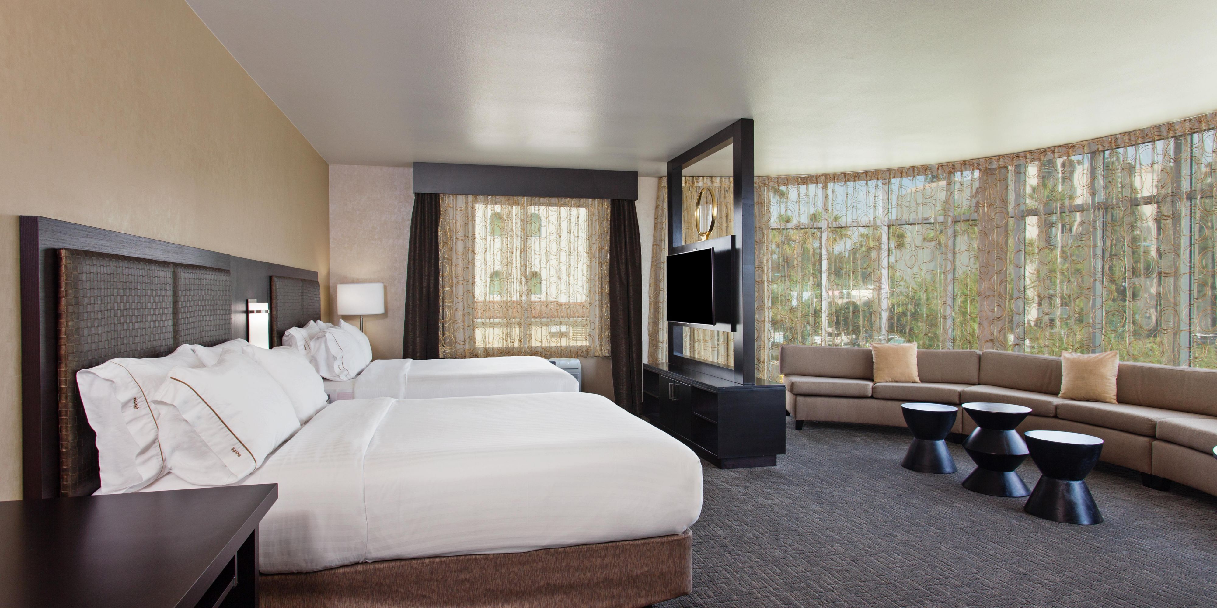 Enjoy the panoramic views of fireworks from the comfort of our largest suite, 750 sq ft with windows stretching from floor to ceiling. Featuring two Queen Beds and an oversized living area with sectional sofa. 