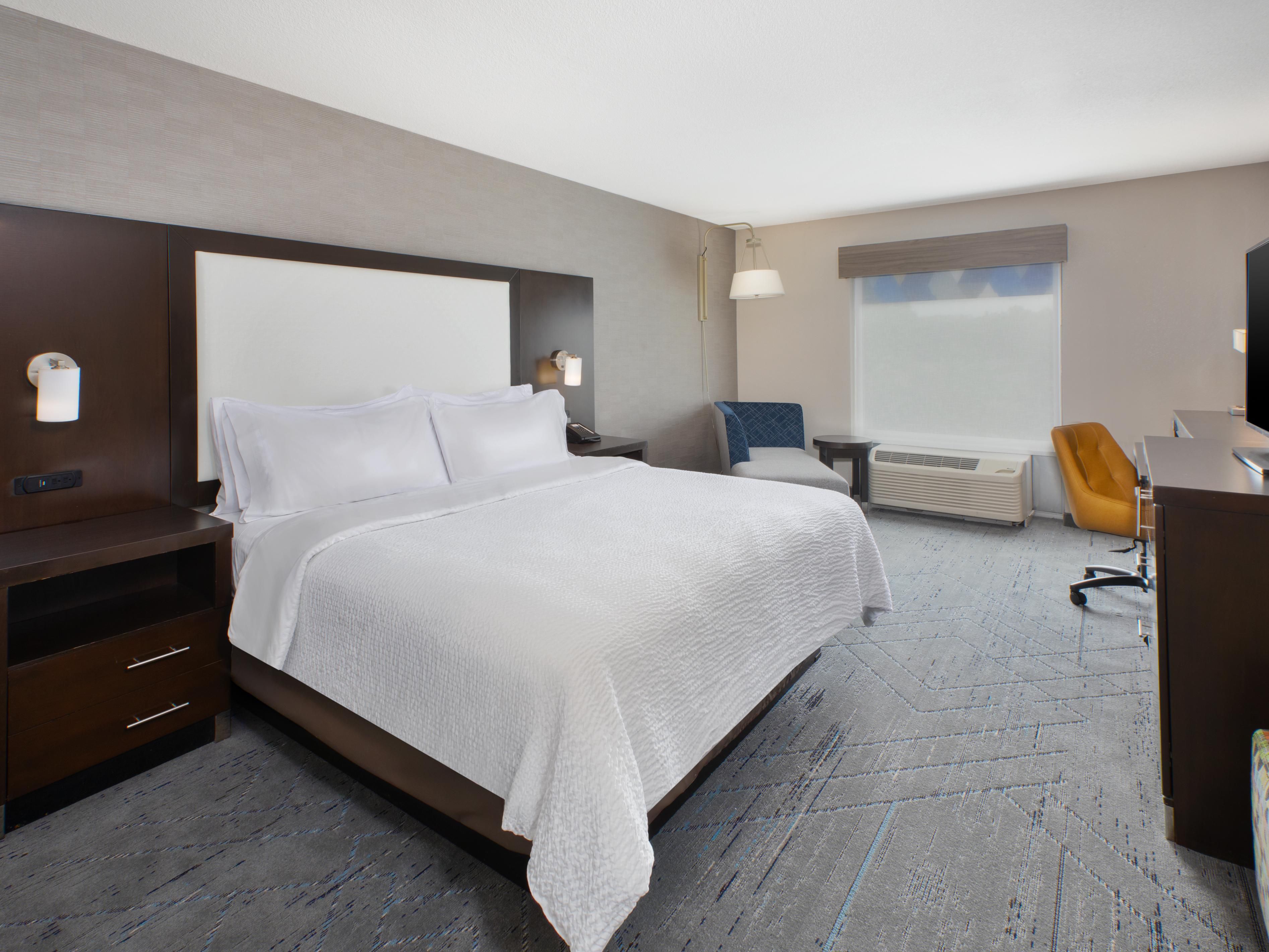 Spacious guest room with a work station and seating area.