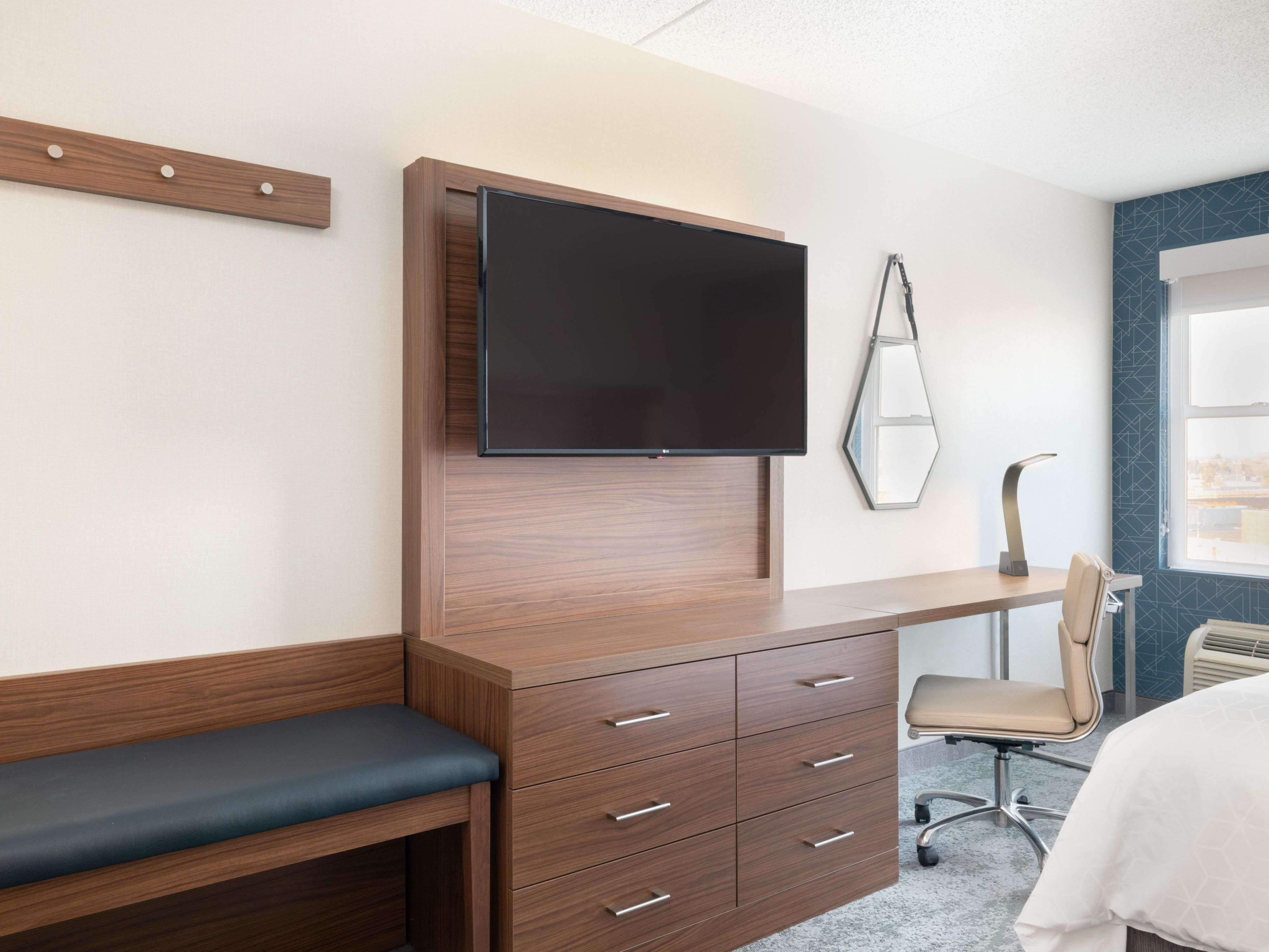 Our standard rooms and suites feature spacious layouts, and select rooms feature living areas with sofa beds and city views. Each room includes a large desk, modern tech features like wireless charging and plenty of outlets, as well as flat-screen TVs, Keurig coffee makers, microwaves, mini-fridges, blackout shades and a laptop safe.