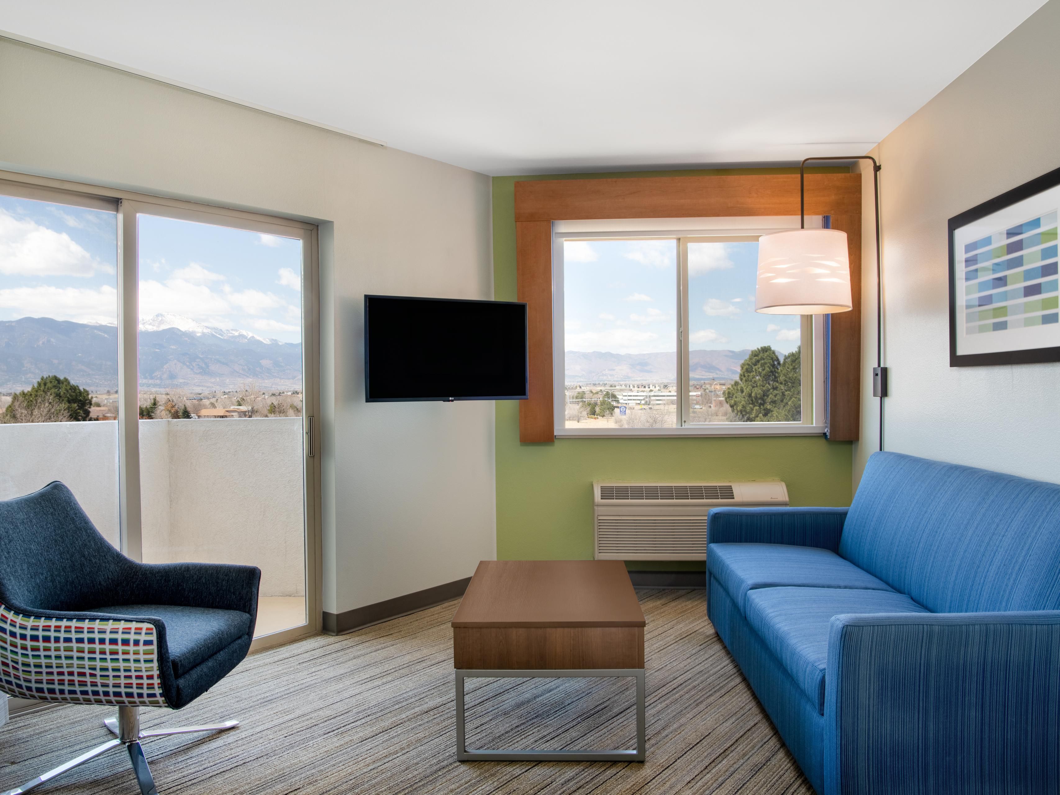1-bedroom suite living area and patio with sliding-glass door.