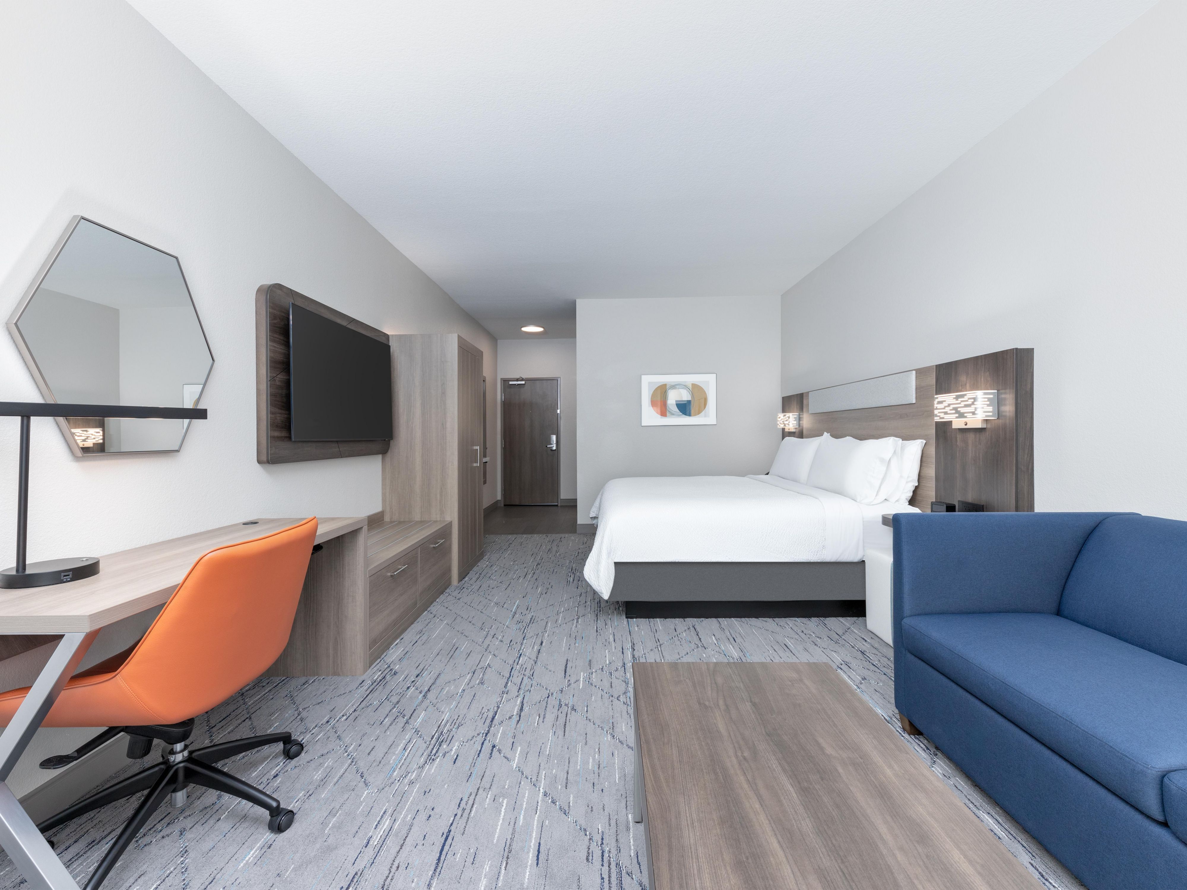 Spacious king bed, living area, TV, and desk for ultimate comfort.