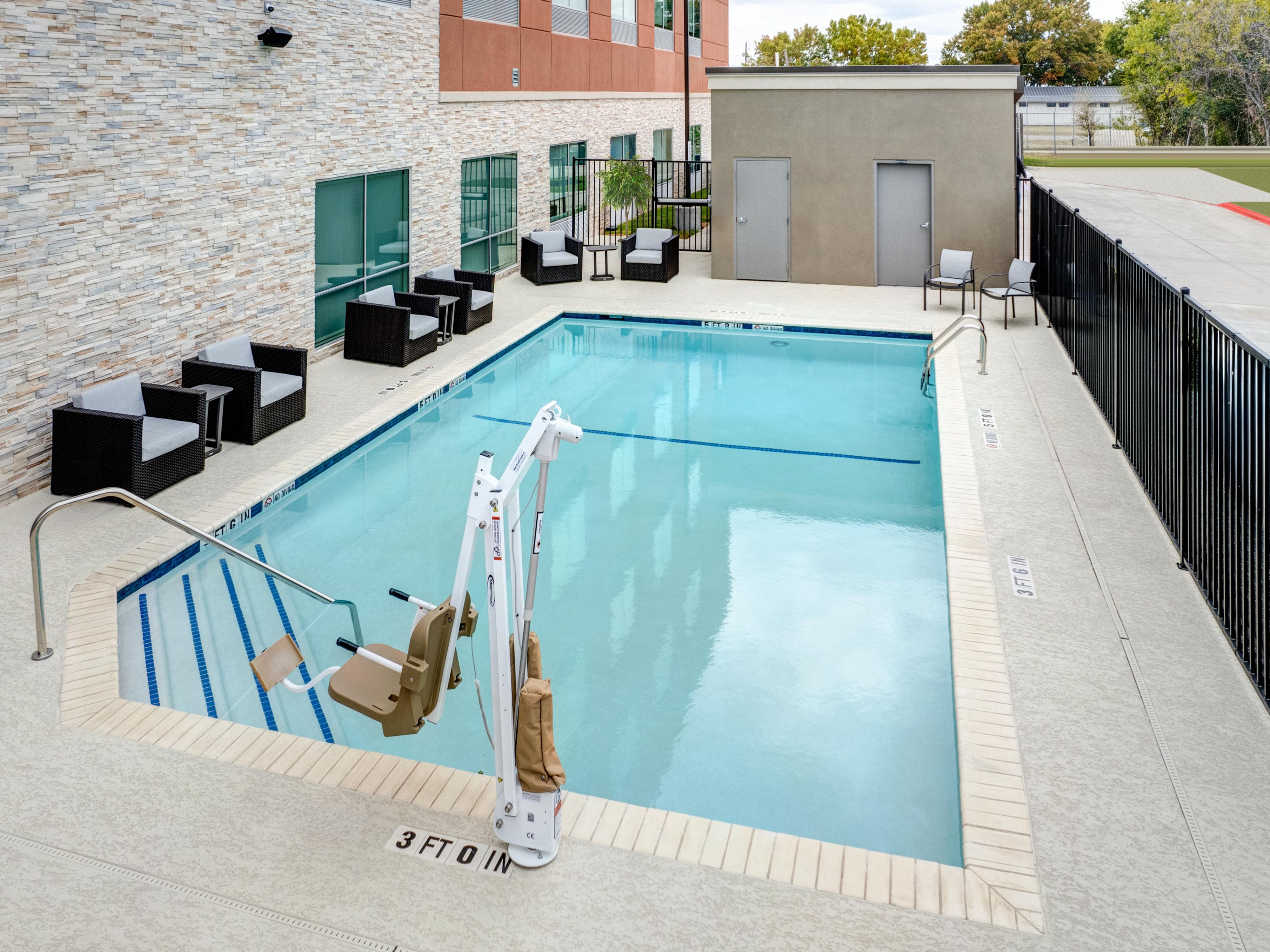 Accessible swimming pool with ADA lift chair for your convenience.