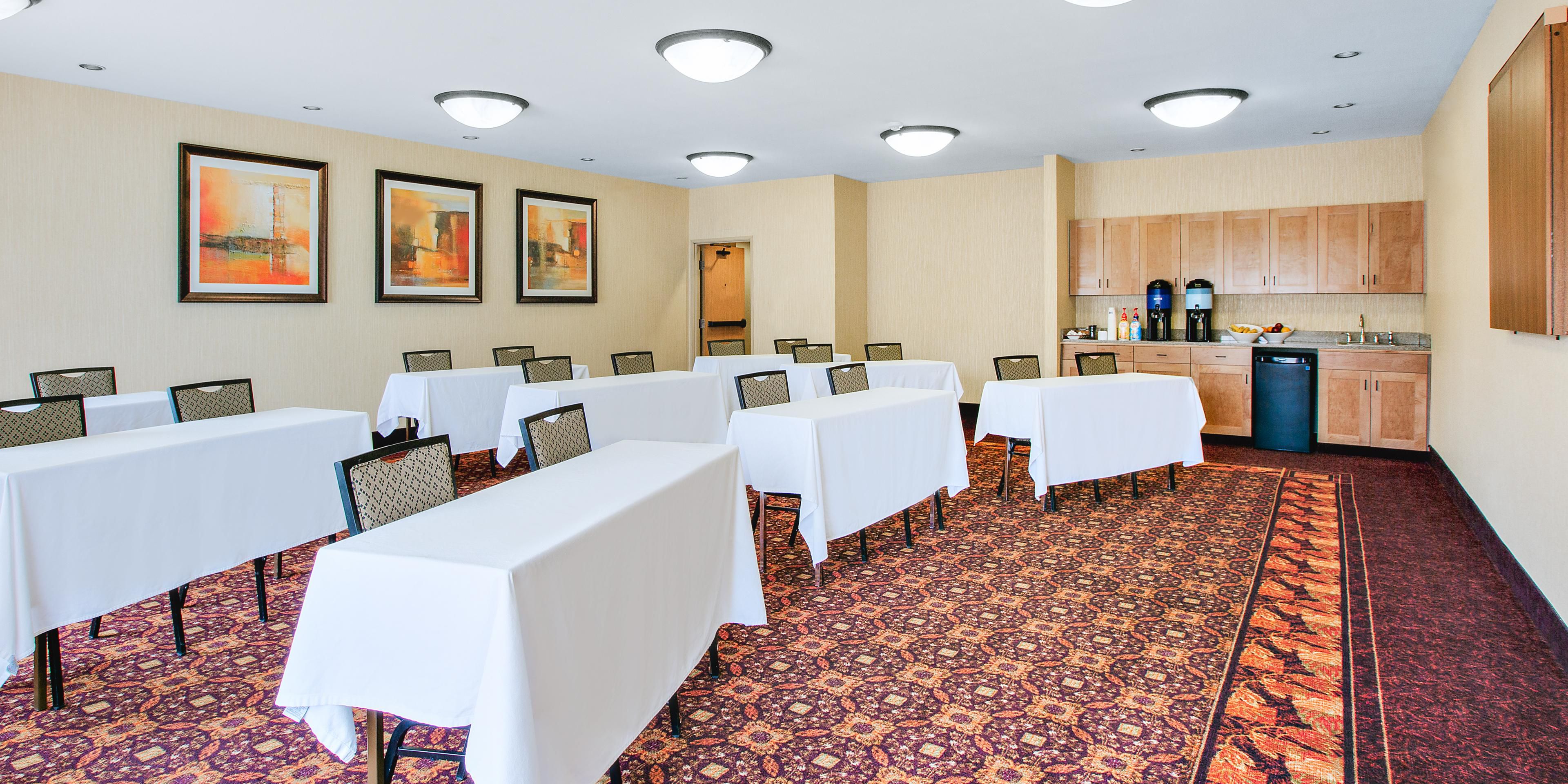 At the Holiday Inn Express, we offer our 900 square foot Meeting Room. We can fit up to 35 people, and will set up the room however you want it! Our room rental fee includes coffee, water, overhead projector, screen, flipcharts, and a podium. We also have breakfast, and additional refreshment options available. We can't wait to host your meeting!