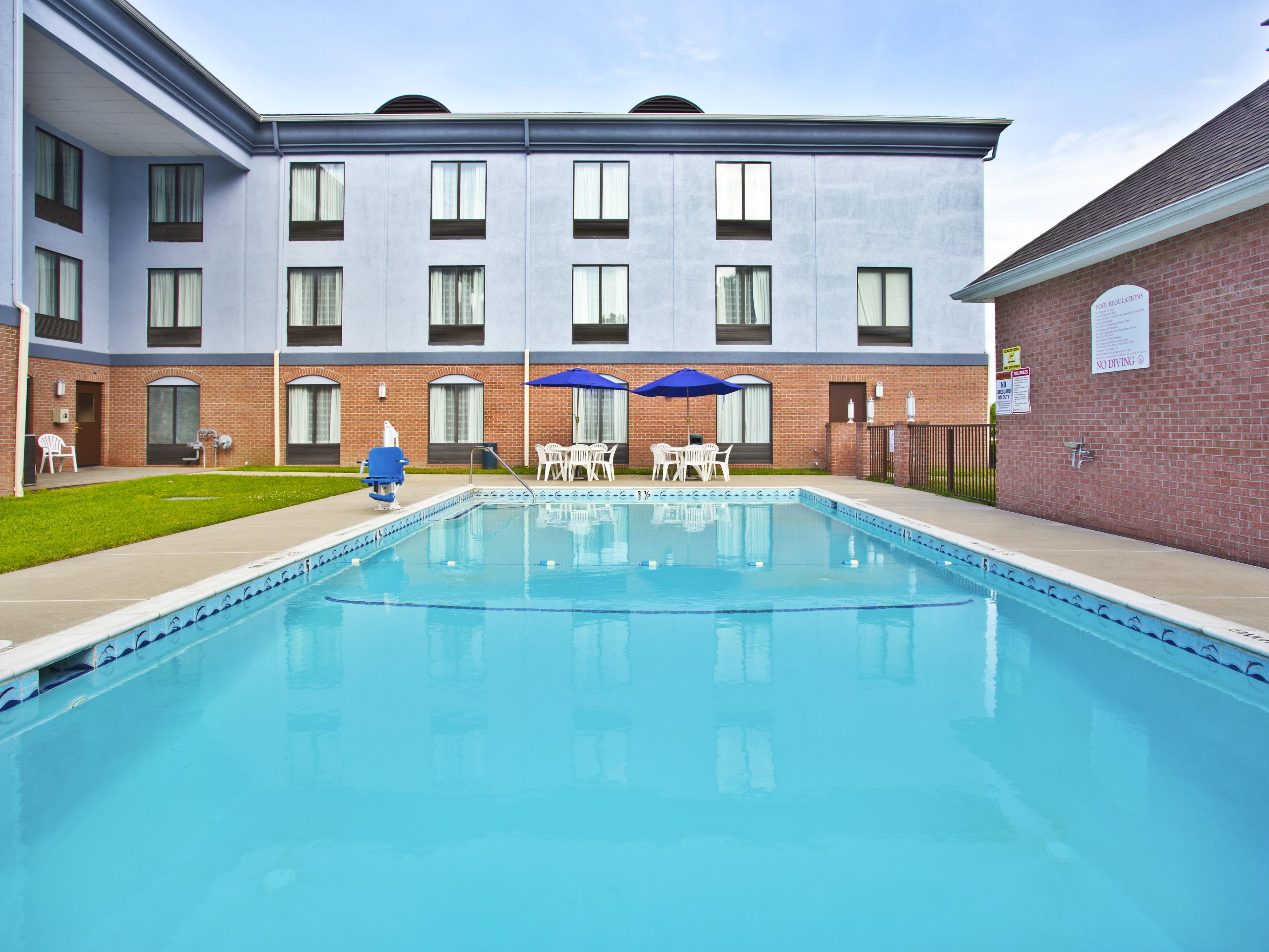 Crystal clear water in the outdoor pool with an ADA  Chair Lift