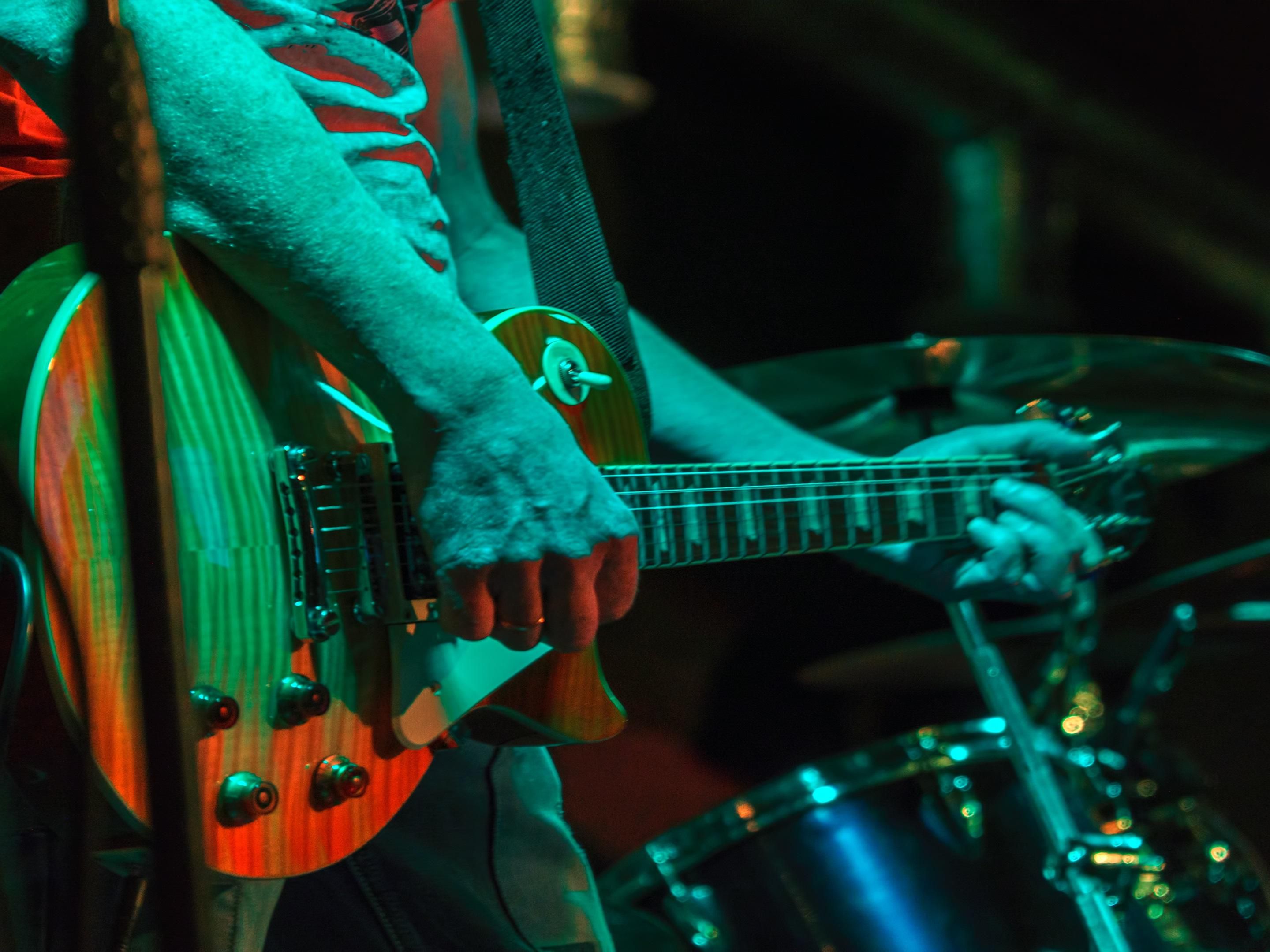 man playing electric guitar on stage
