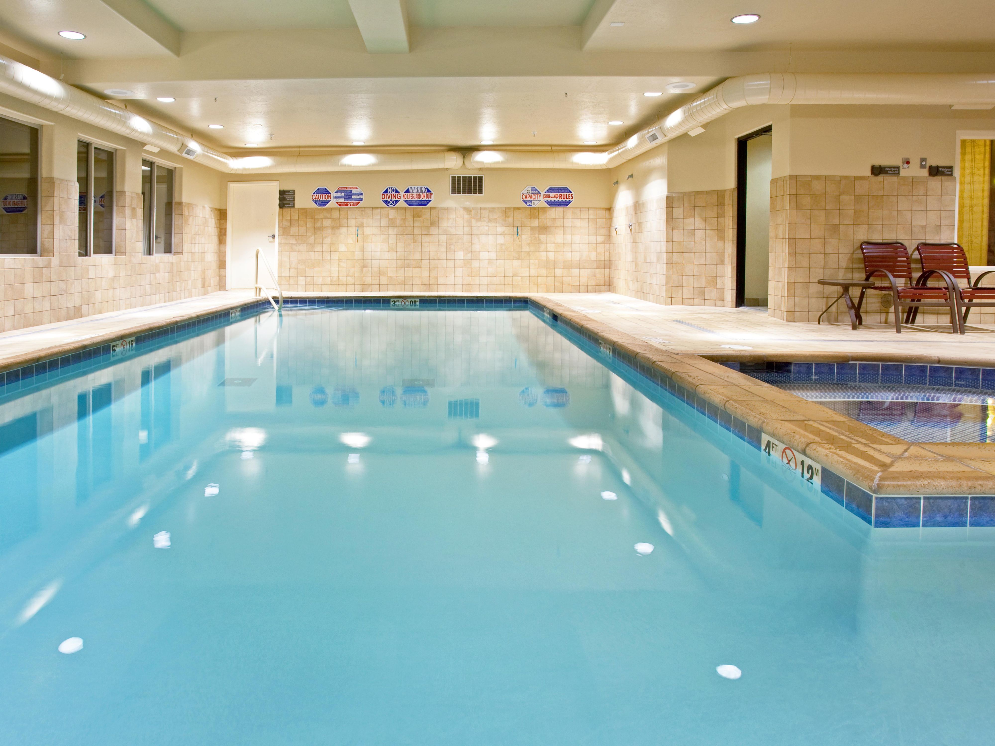 Indoor pool area with hexagonal tile flooring and design.