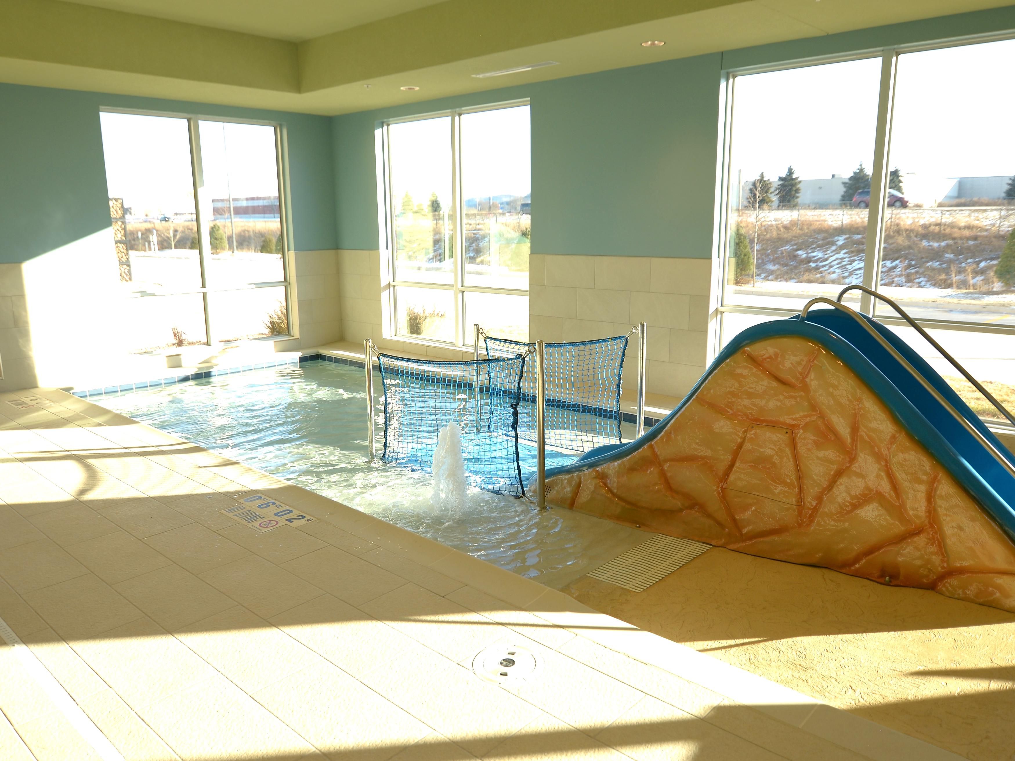 In addition to the pool and hot tub, children can delight in a zero depth wading pool designed specifically for them. Our kiddie pool features a water sprinkler and slide for their enjoyment. This pool is for children only and has a maximum depth of one and a half feet. 