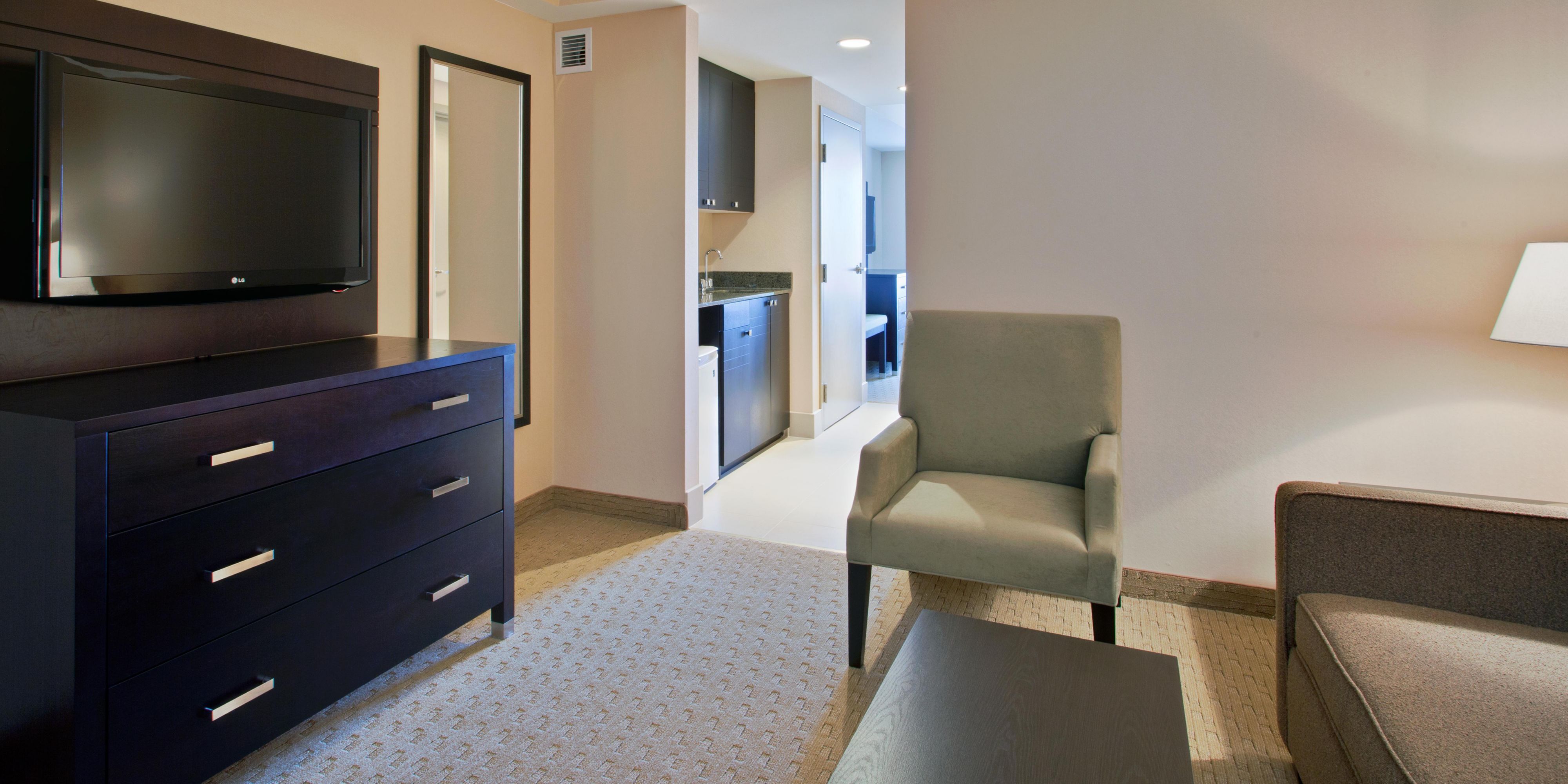 Our suites come with either one king bed or two queen beds, a living area, and a kitchenette. The kitchenette includes a microwave, mini-fridge, and wet bar. A grocery store is located beside the hotel and is open 7 days a week.