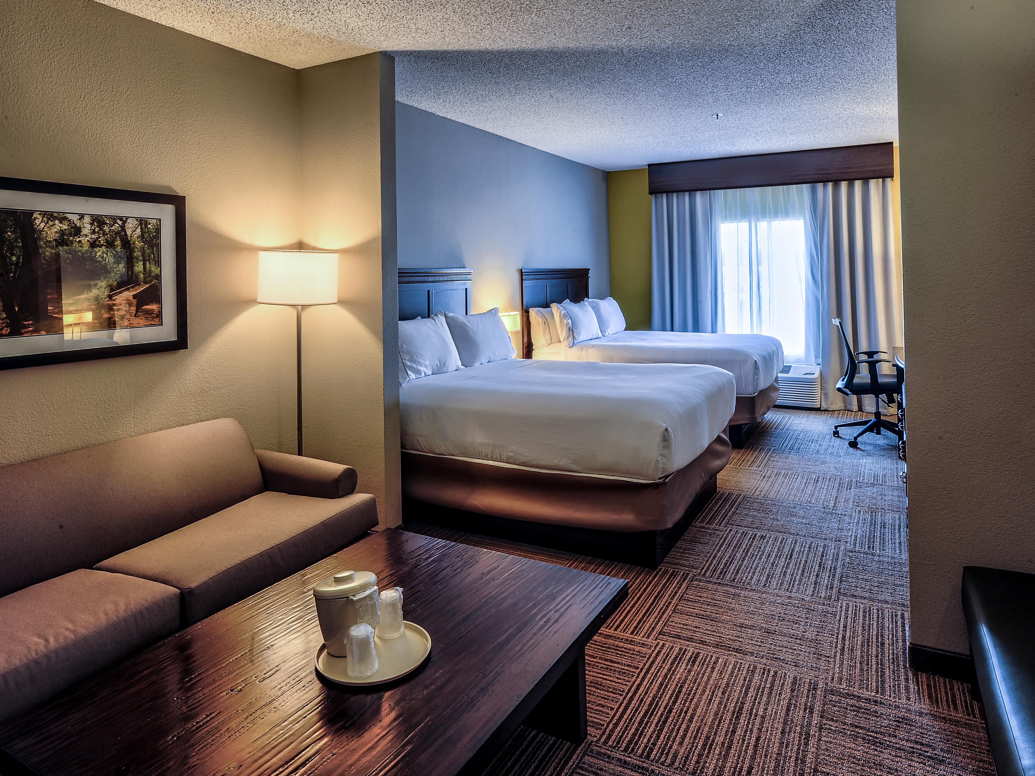 Enjoy a sleeper sofa and extra seating such as armchairs and benches. Microwave, wet bar, and mini refrigerator are all included. You have your choice of a King bed or two Queens.