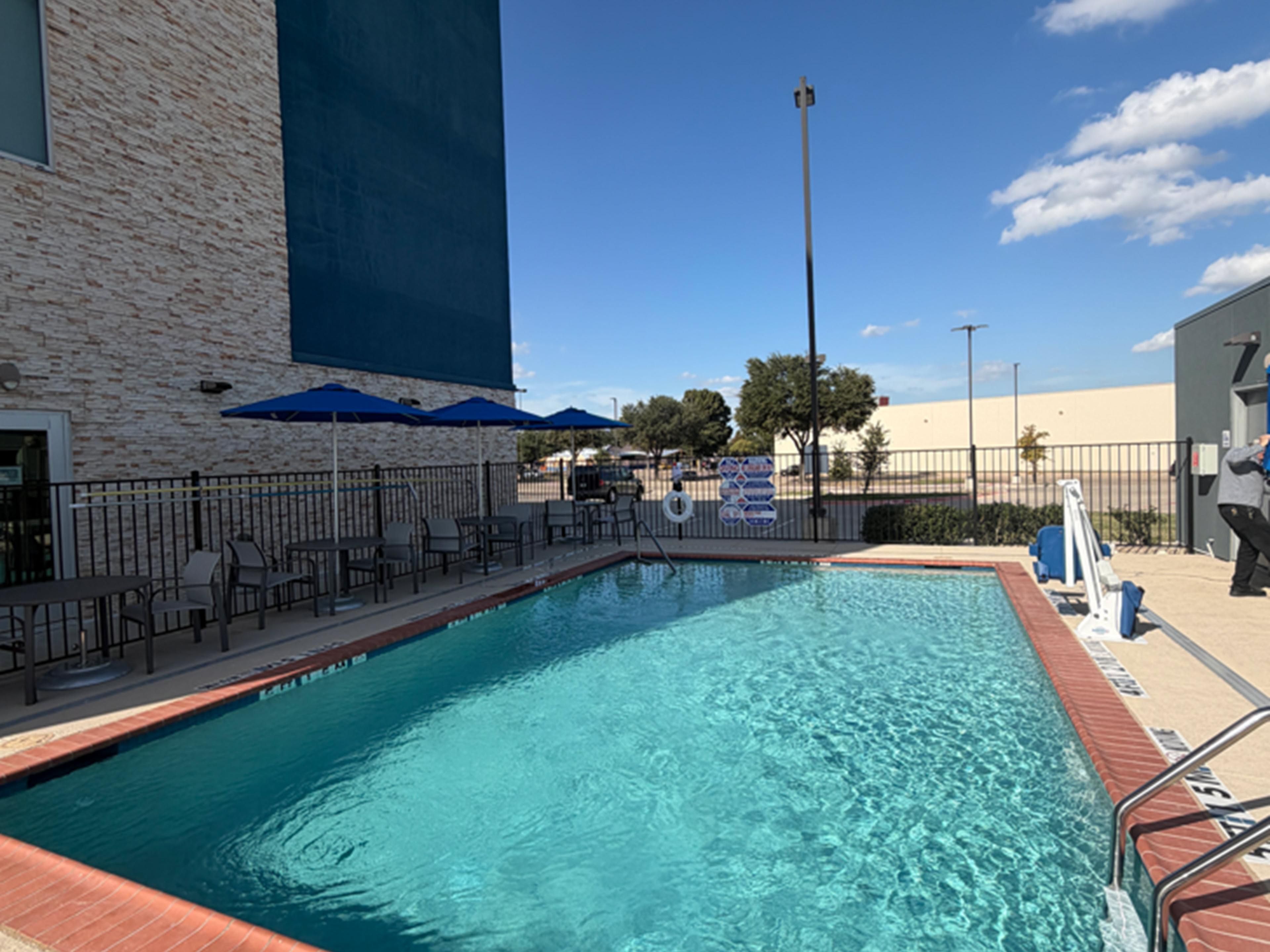Relax poolside at our outdoor pool in Plano.