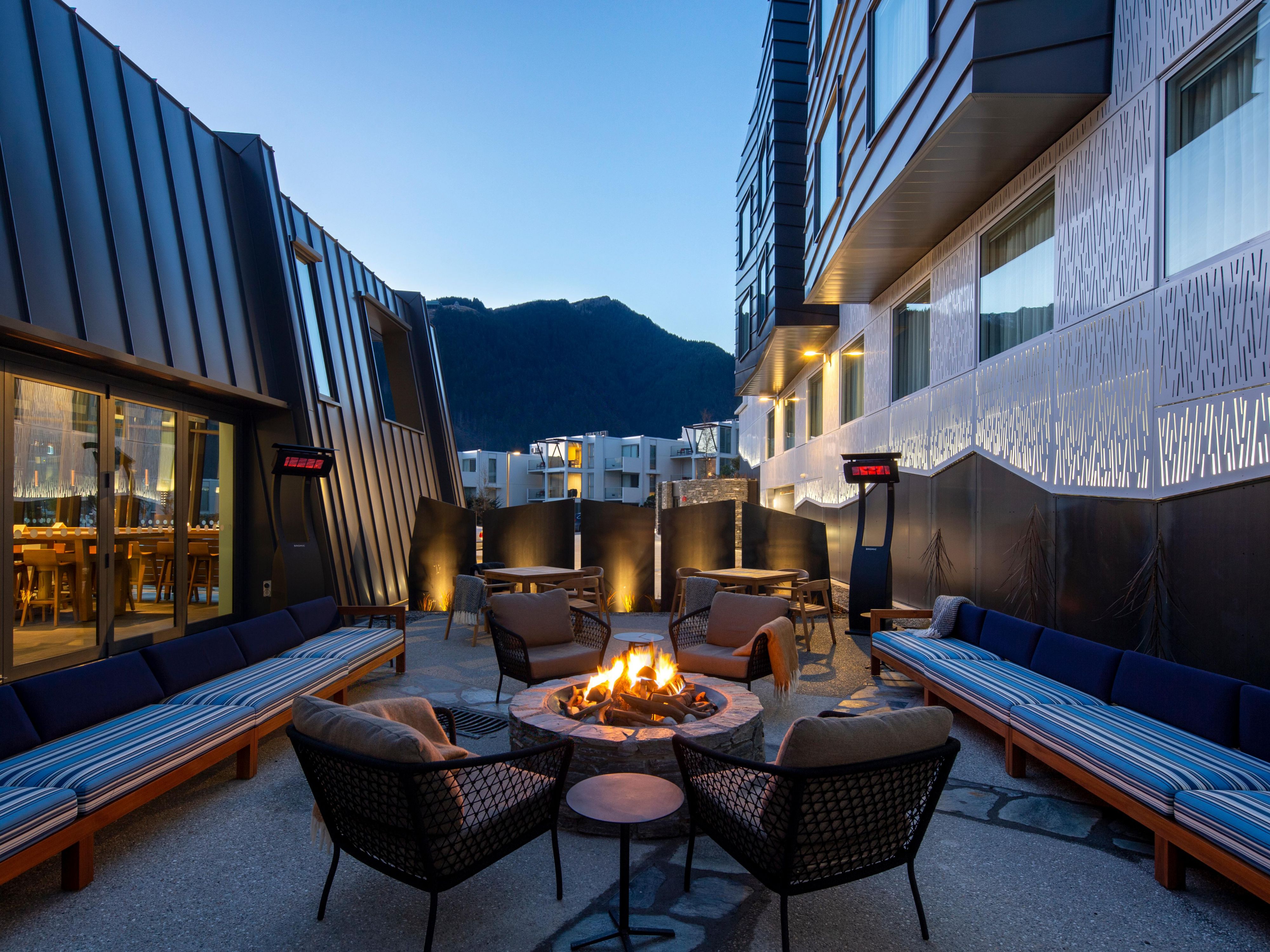 Fire pit lounge with alpine views at Queenstown hotel