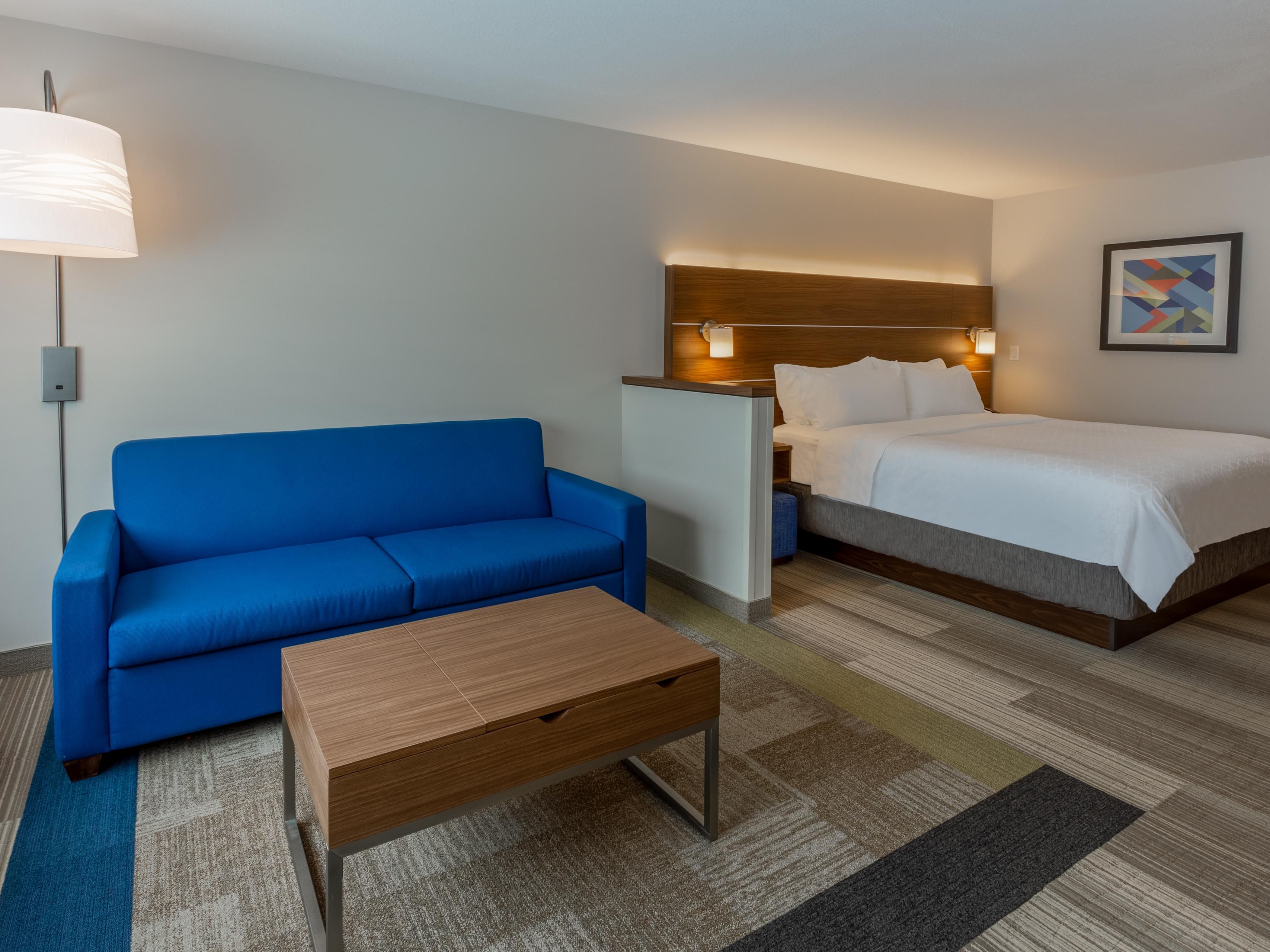 King Bed Guest Room Suite with plush bedding and pull out sleeper