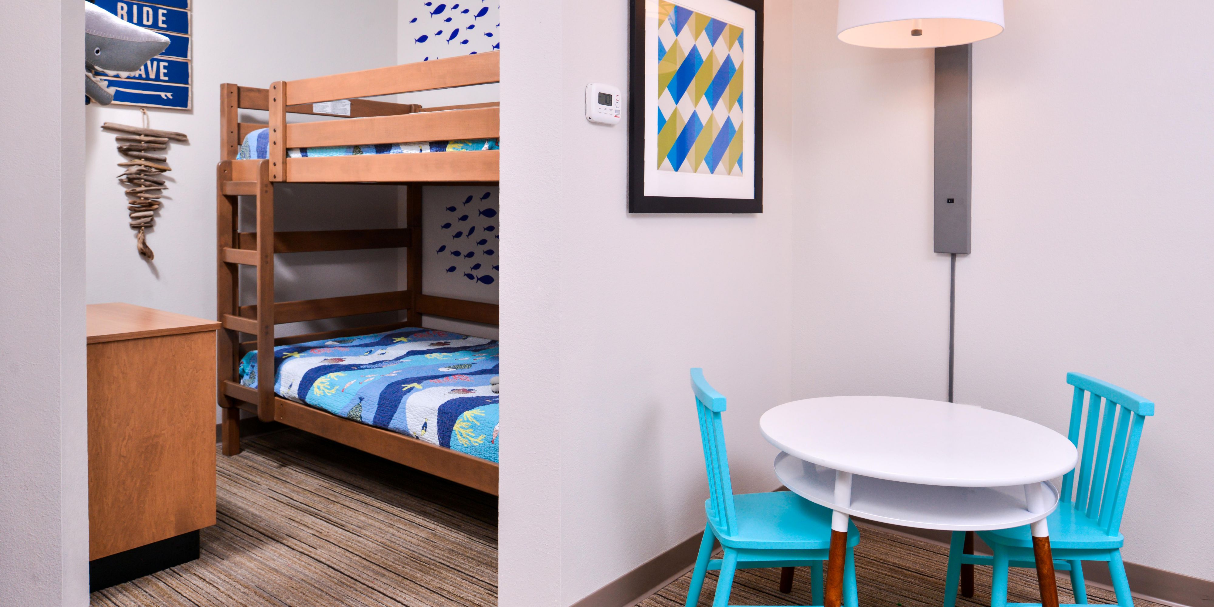 Pack up the kids and enjoy a cool getaway in our sea-themed family suite featuring twin bunk beds, a king bed, kids play table, microwave, and mini refrigerator!