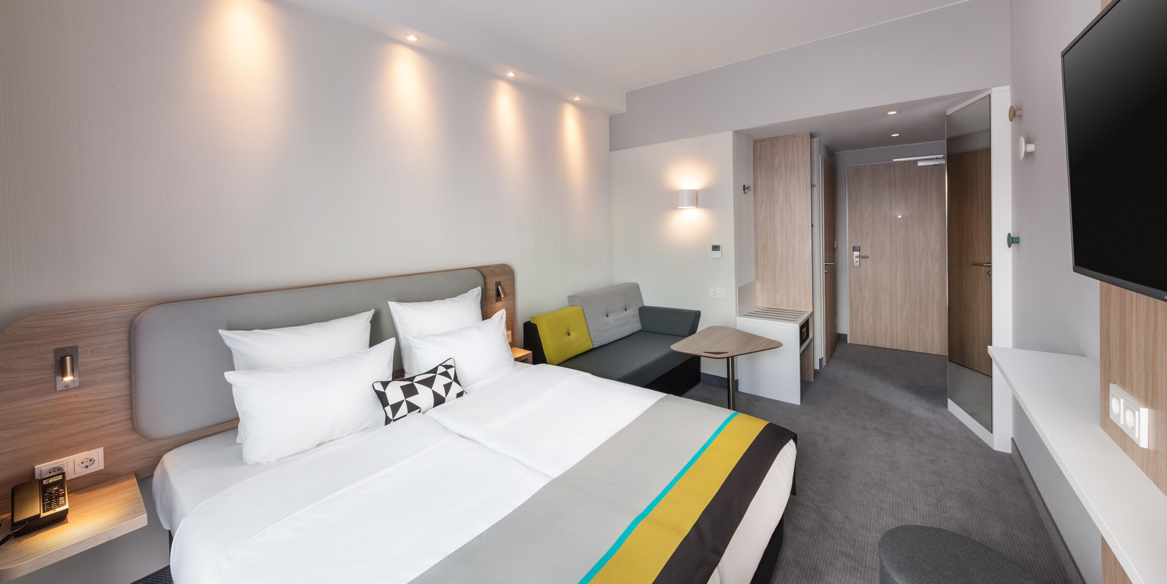 Rest easy at our Dusseldorf hotel, offering newly-renovated, soundproof rooms for the perfect night's sleep. Enjoy travel essentials, including comfortable beds with your choice of pillows, flatscreen Smart TVs, free Wi-Fi, a coffee maker, and an ergonomic workspace with USB charging. Families and groups will love our rooms with a sofa bed.