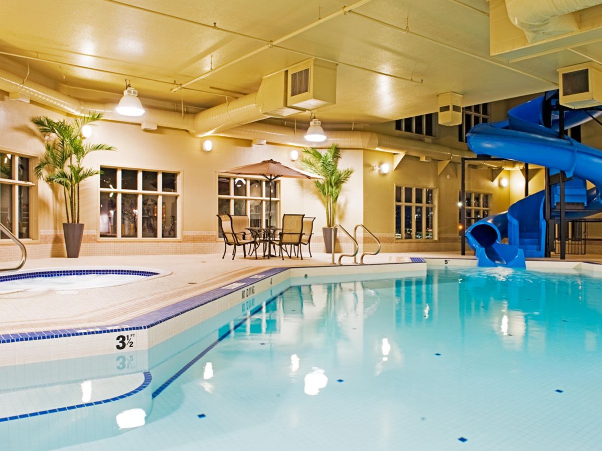 Indoor swimming pool with waterslide and hot tub at Holiday Inn Express Grande Prairie