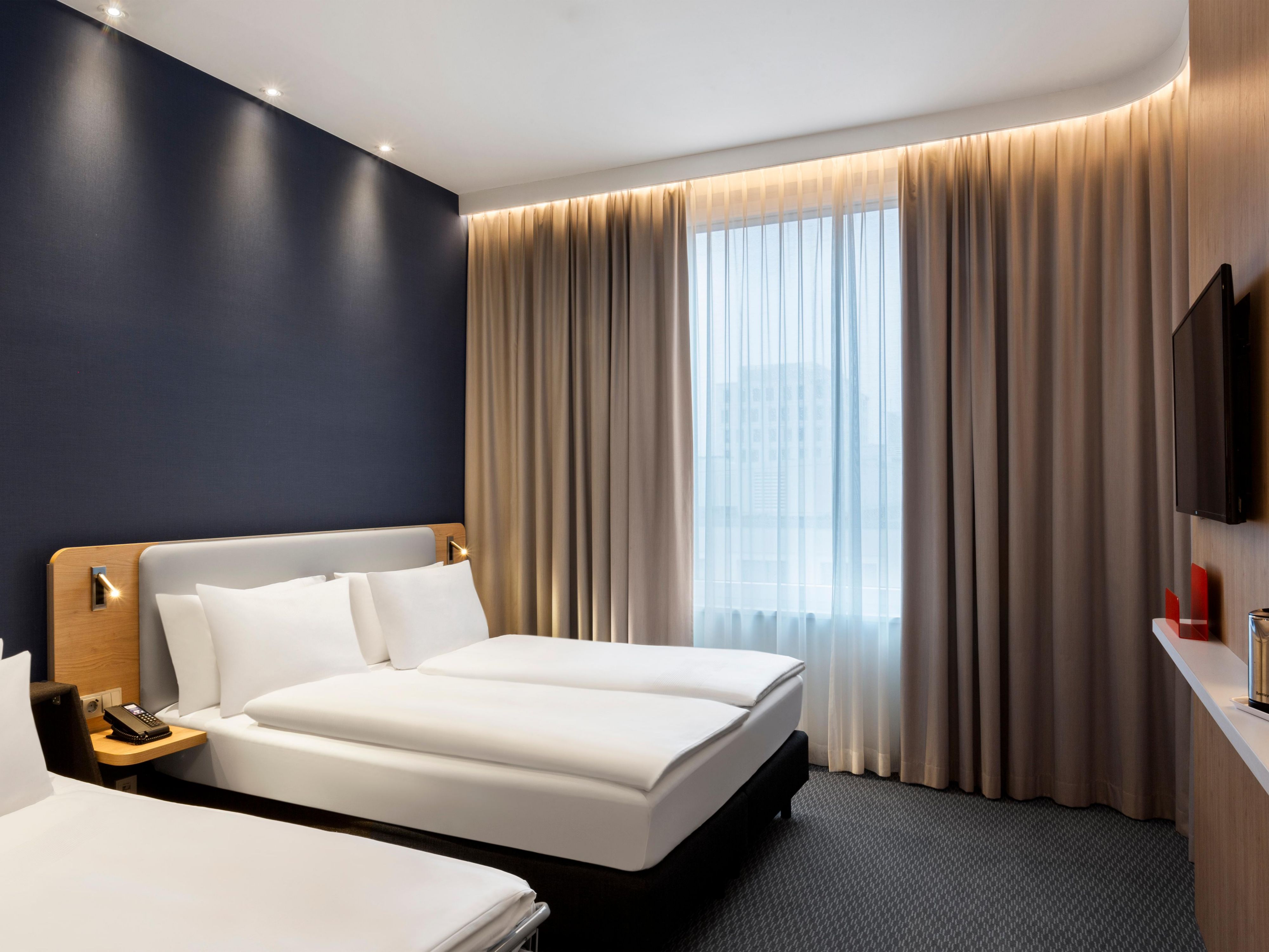 Enjoy our family rooms for a fun experience in Munich, especially in summer. Unwind in rooms that include a double sofa bed, complimentary Wi-Fi, air conditioning, a flat-screen TV, and a mobile desk.