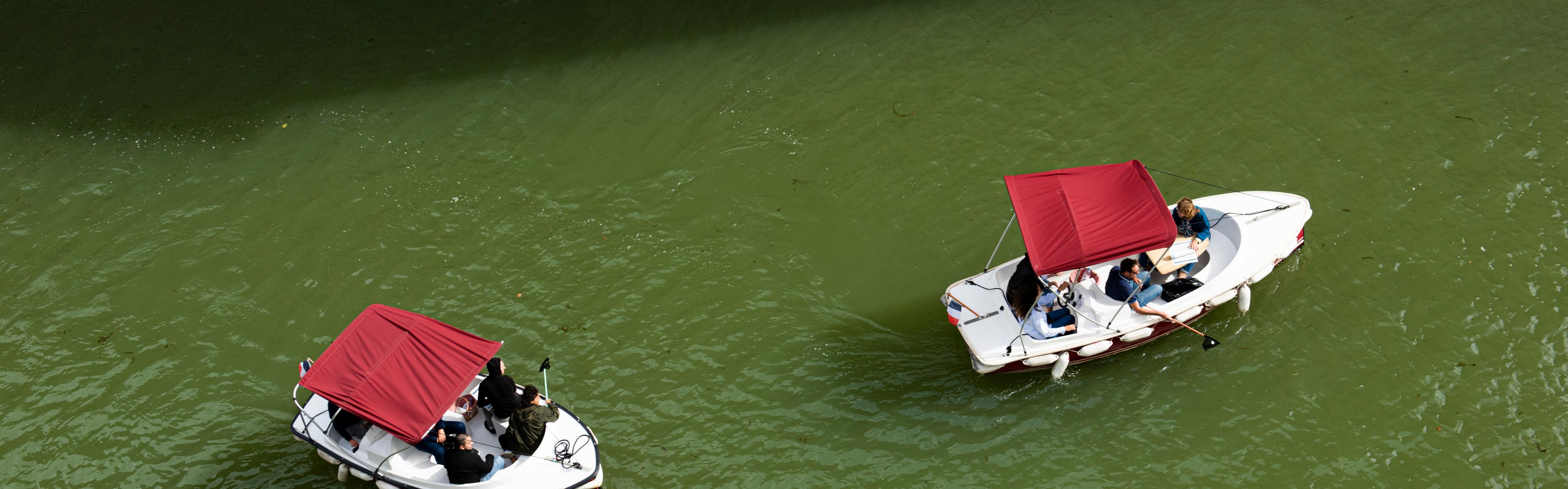 Small green electric boat activity on the canal