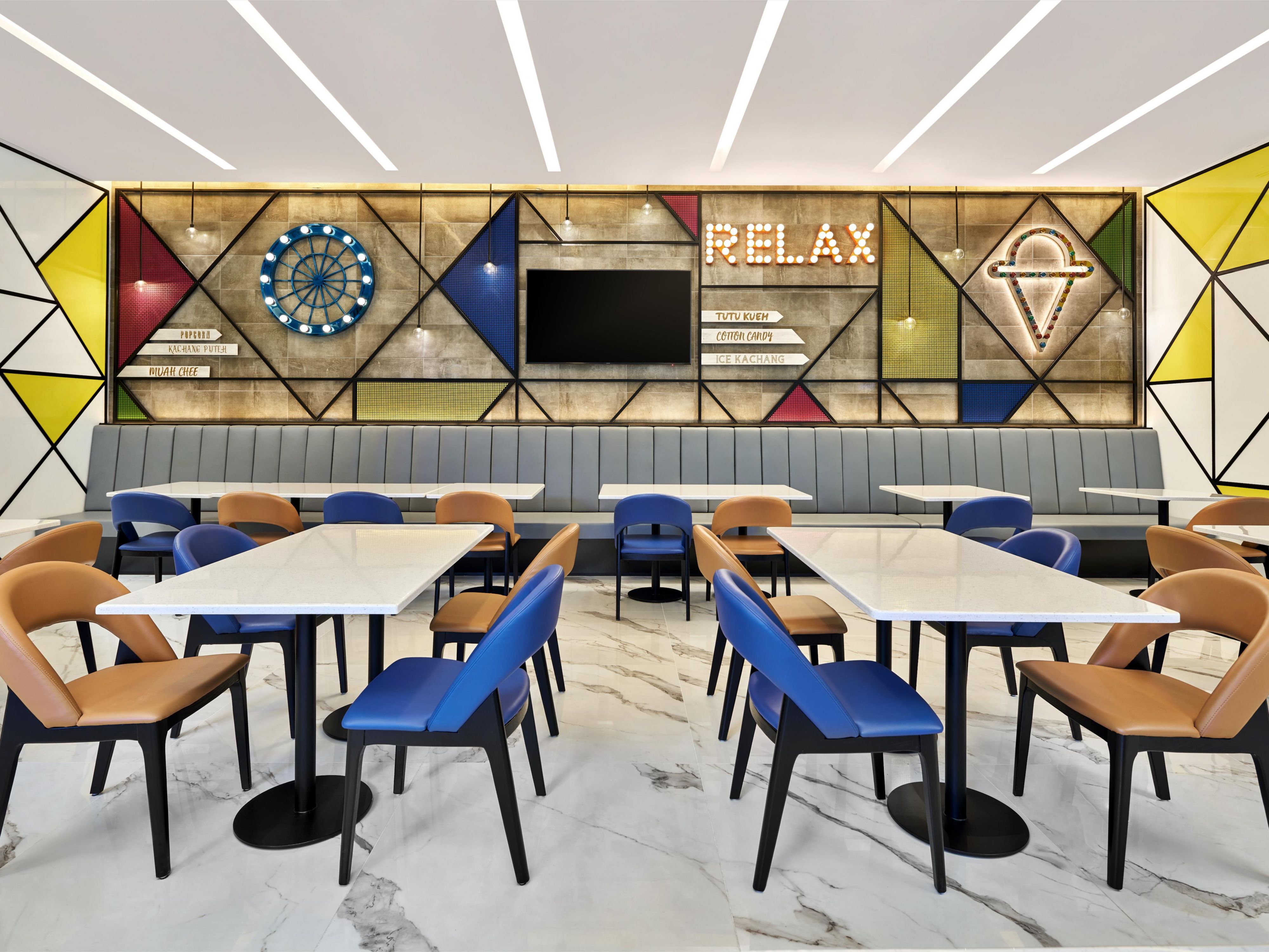 Image 95: The Great Room features a carnival-themed decor with pops of bold colours inspired by the iconic New World Amusement Park from the 1920s-60s in Singapore. Guests can enjoy breakfast here from 6:30 AM to 10:30 AM or wind down with a drink and some snacks from our Great Room Bar in a casual and friendly atmosphere throughout the day. 