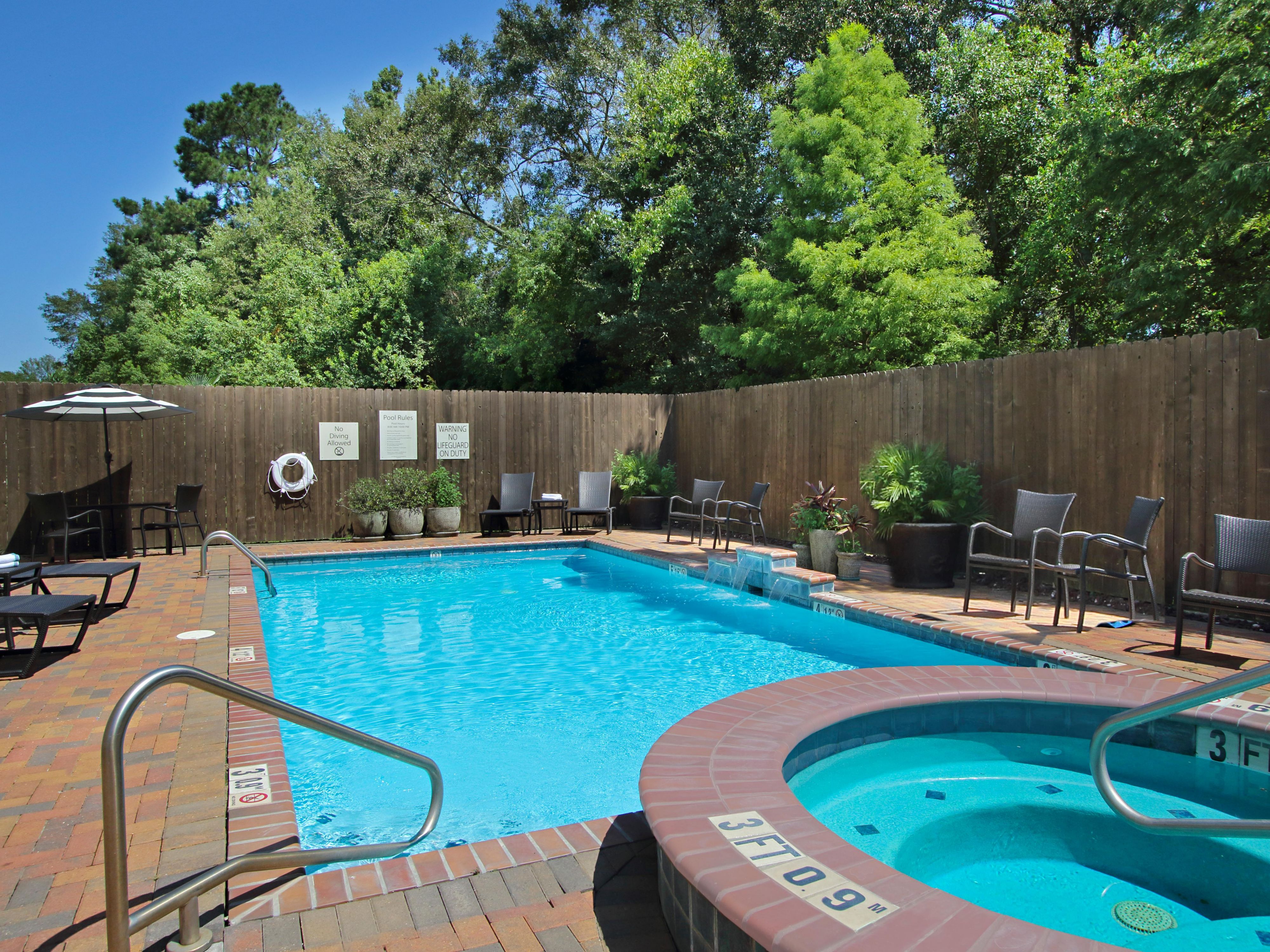 Outdoor pool, hot tub and privacy fence at Holiday Inn Hammond
