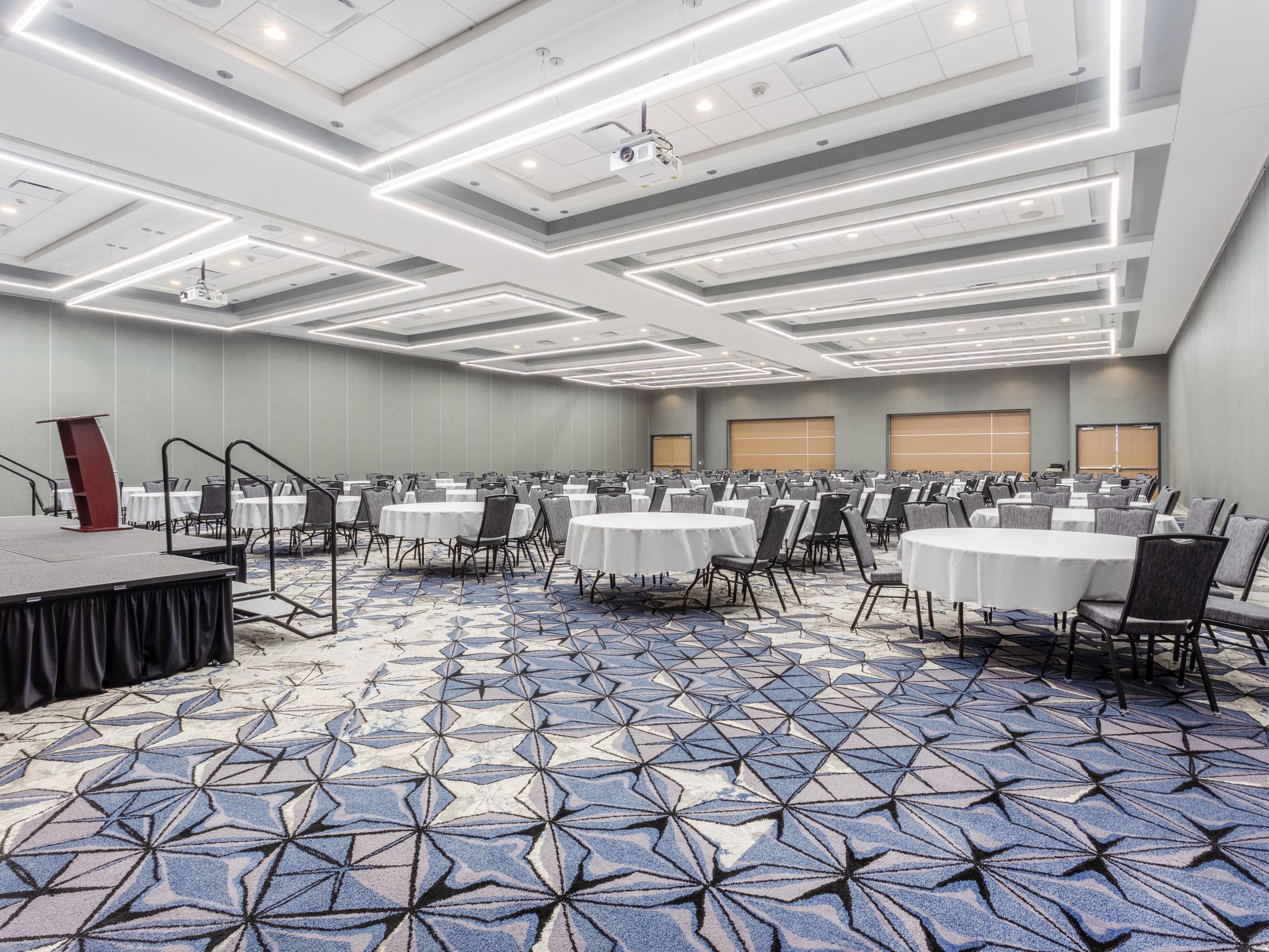 Experience the perfect venue for corporate events, associations, government seminars, weddings, and reunions at our Cedar Falls Event Ctr. Our 14,000 sq ft versatile venue, and 9,000 sq ft indoor/outdoor pre-function area with patios and fire pits cater to your specific needs. Enjoy event planning, A/V equipment, catering, and group accommodations.