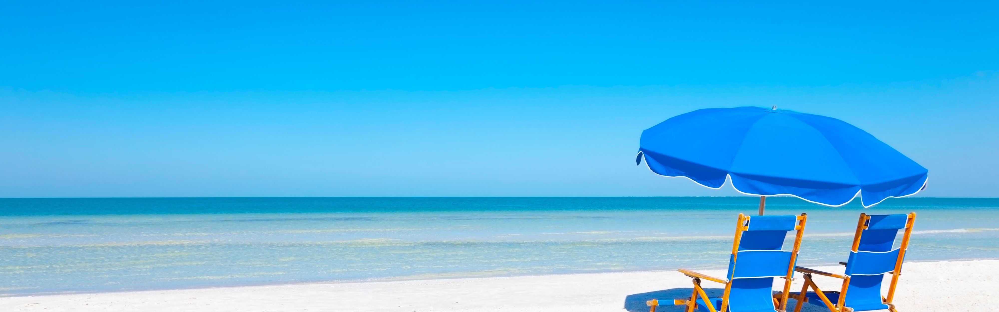 Beach with clear blue water and beach chairs