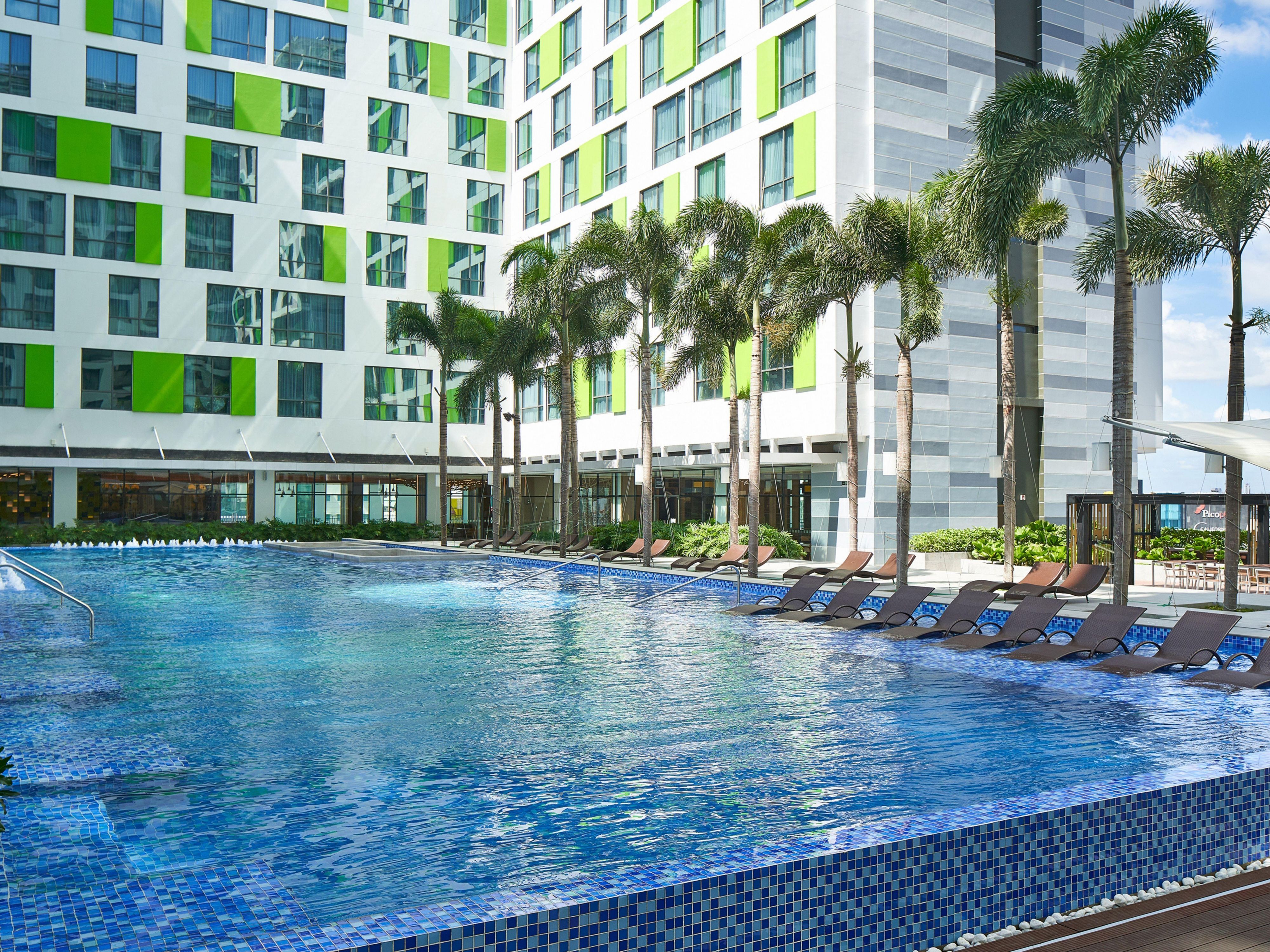 Escape the heat and embark on a refreshing retreat at our outdoor swimming pool, surrounded by palm trees. The adjacent 24/7 fitness centre beckons for invigorating workouts, ensuring a perfect blend of relaxation and well-being throughout your stay. 
