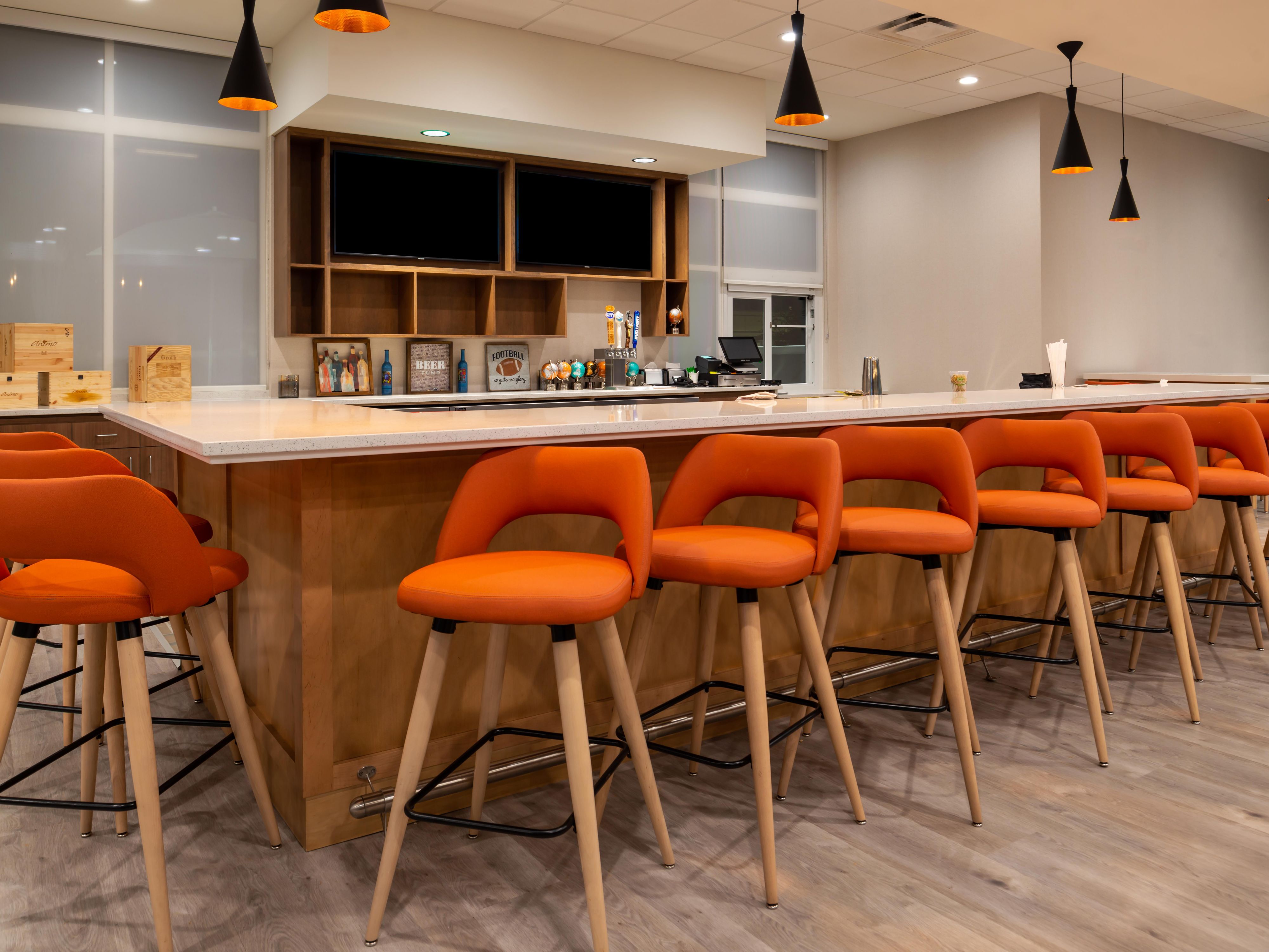 Bar area with bright orange seating at Toast to Toast. 
