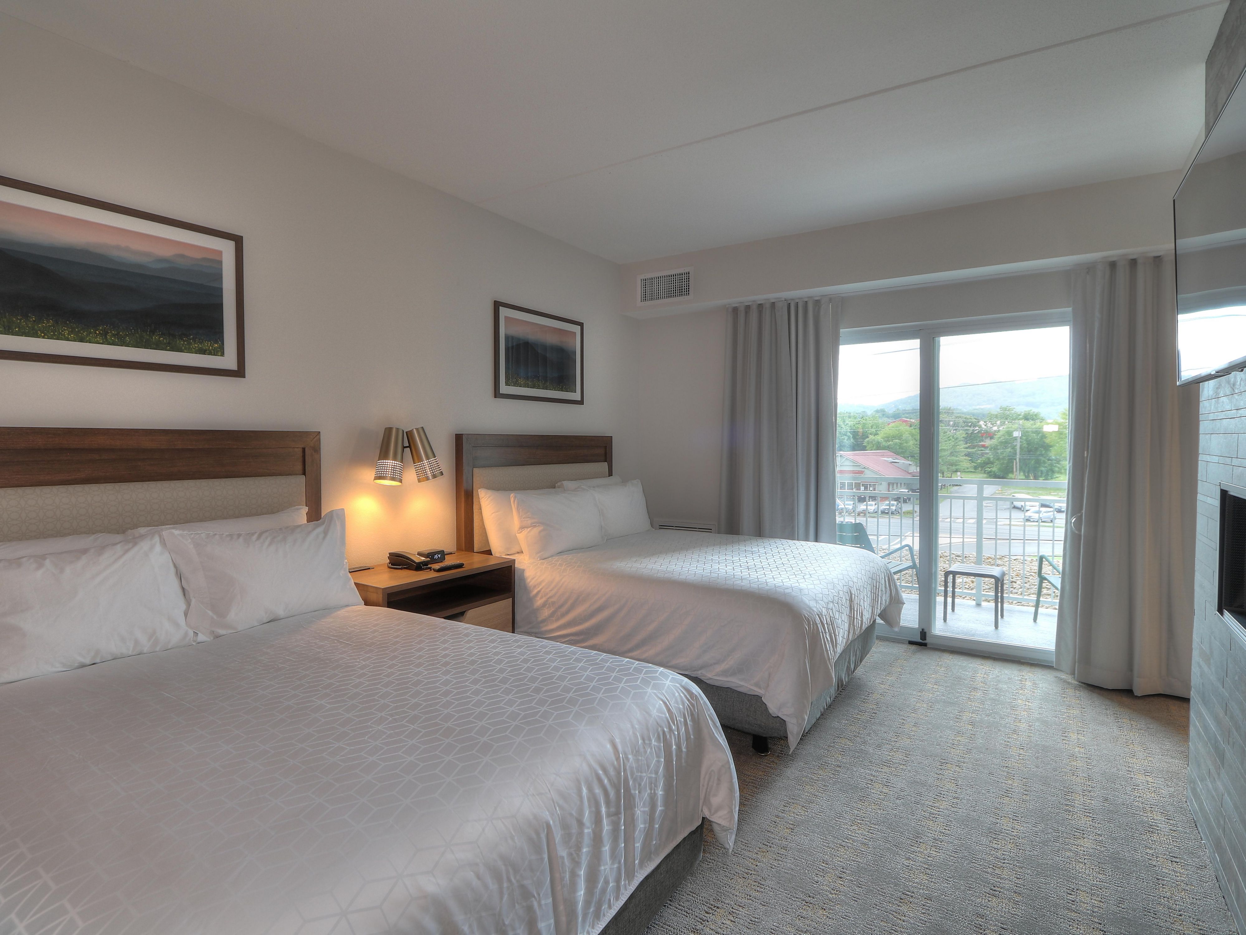 Step into our spacious  rooms and suites, featuring mid-century modern décor and convenient amenities.  Enjoy free Wi-Fi, a Keurig coffee maker, mini fridge, premium bedding, and a 50" LCD TV. Select rooms offer balconies with scenic views, while suites with fireplaces 