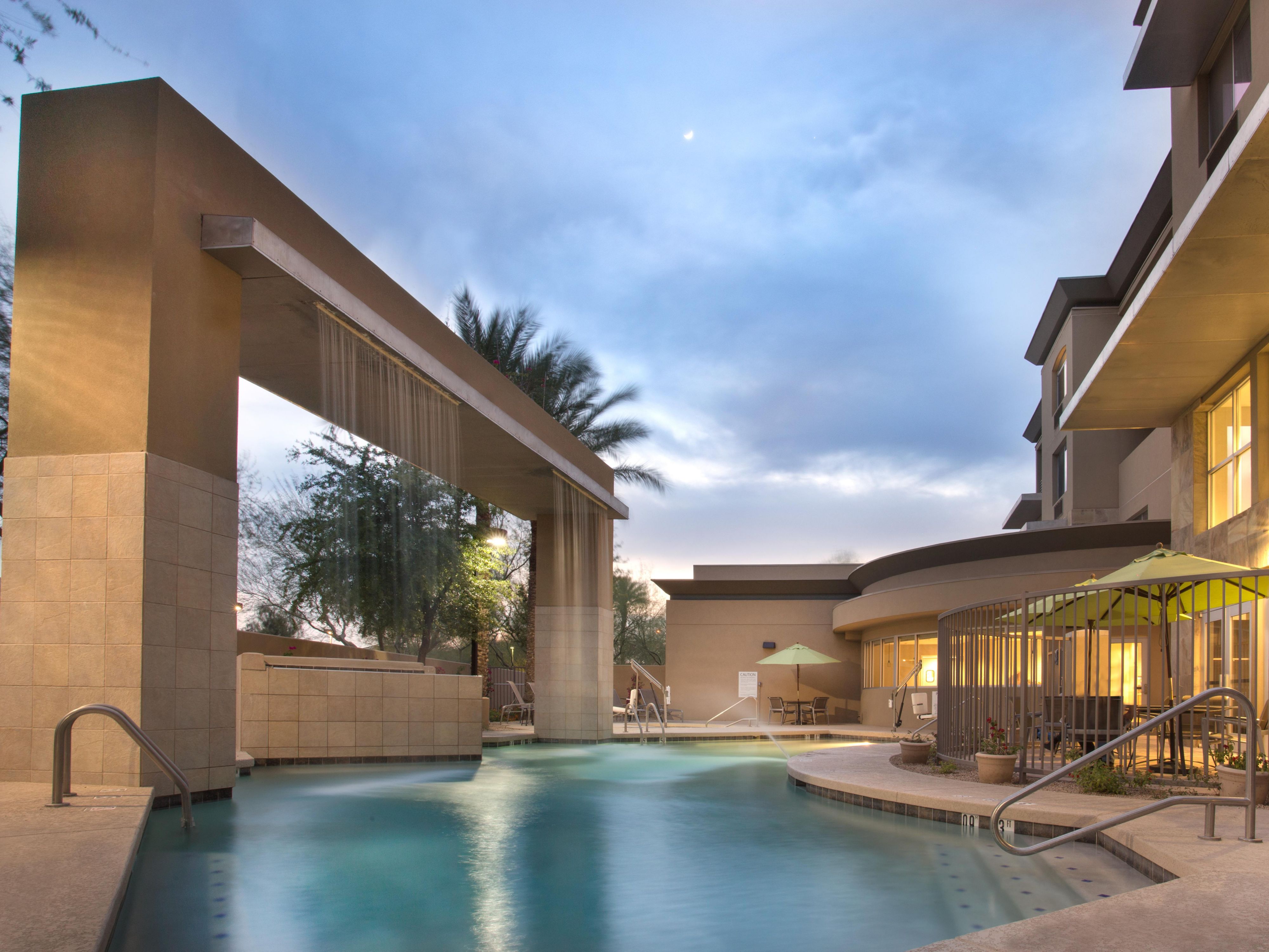 Outdoor swimming pool with waterfall