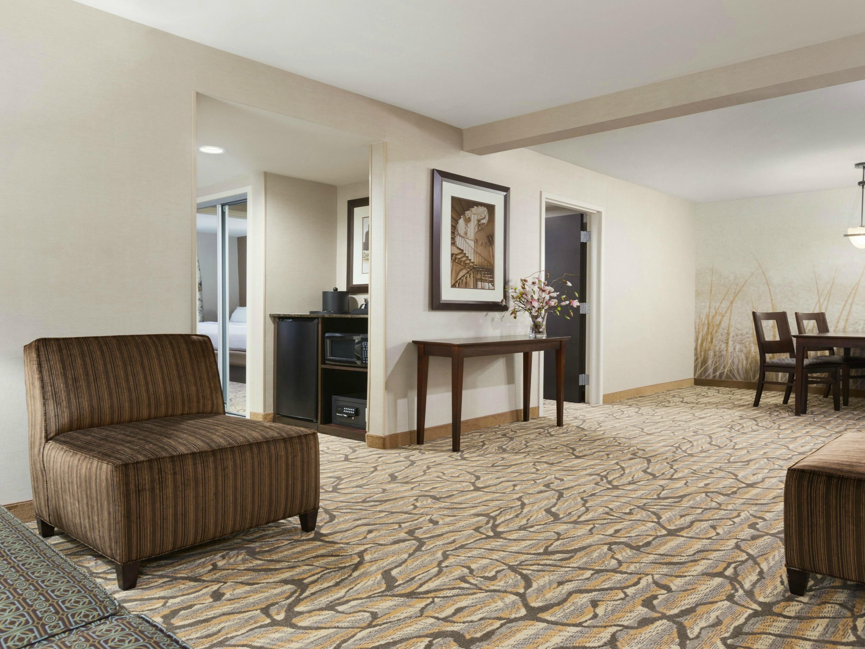 Spacious One Bedroom Suite featuring a living room with a sleeper sofa pull-out, microwave, Keurig coffee maker, mini-refrigerator, 2 televisions and a separate bedroom. Two separate Bedrooms and Bathrooms with a large Living Room and Dining Area featuring a sleeper sofa pull-out, microwave, Keurig coffee maker, mini-refrigerator and 3 televisions.