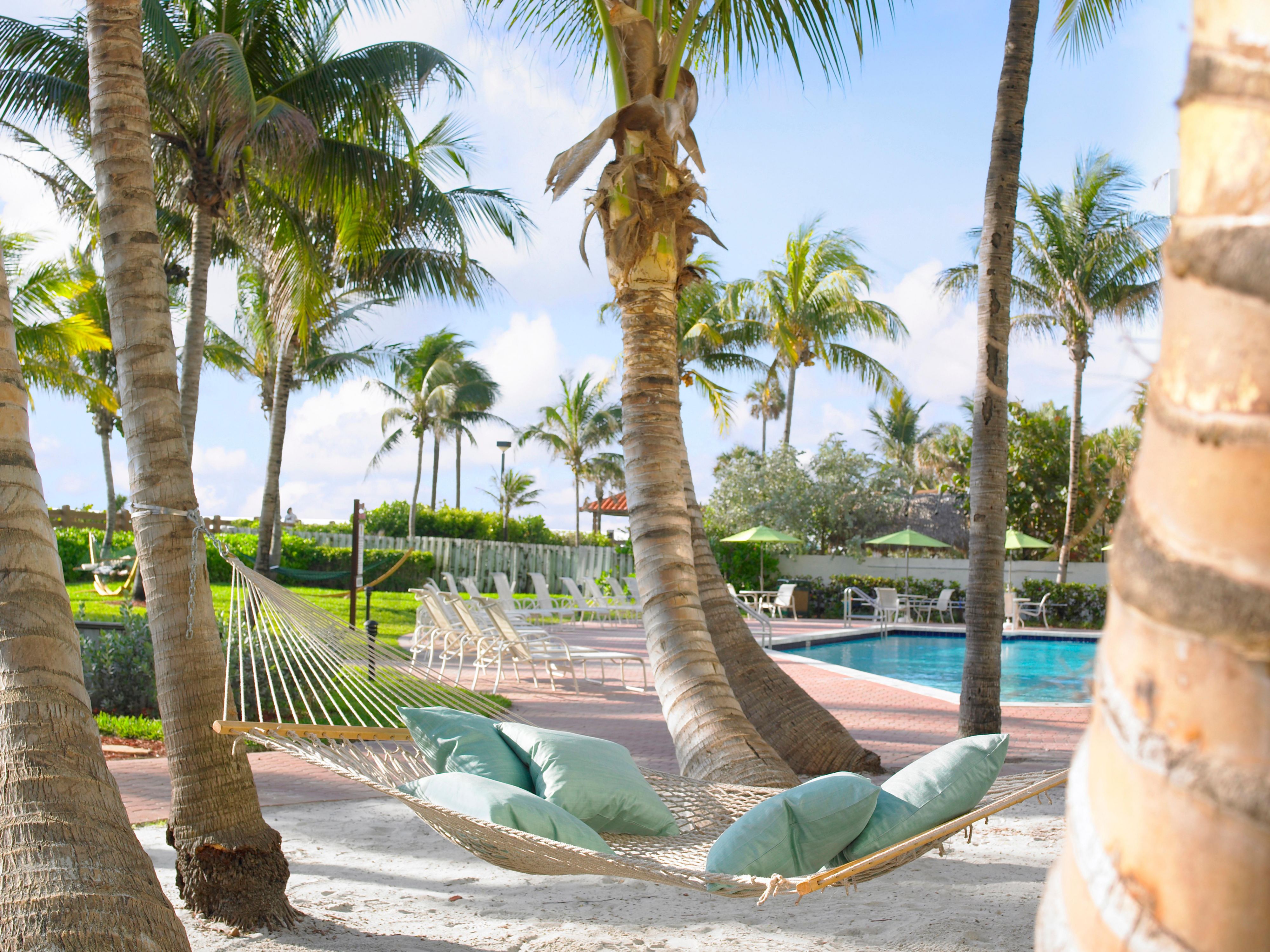 The Beach is our backyard! Relax at our poolside hammocks conveniently located next to our Tiki Hut!  